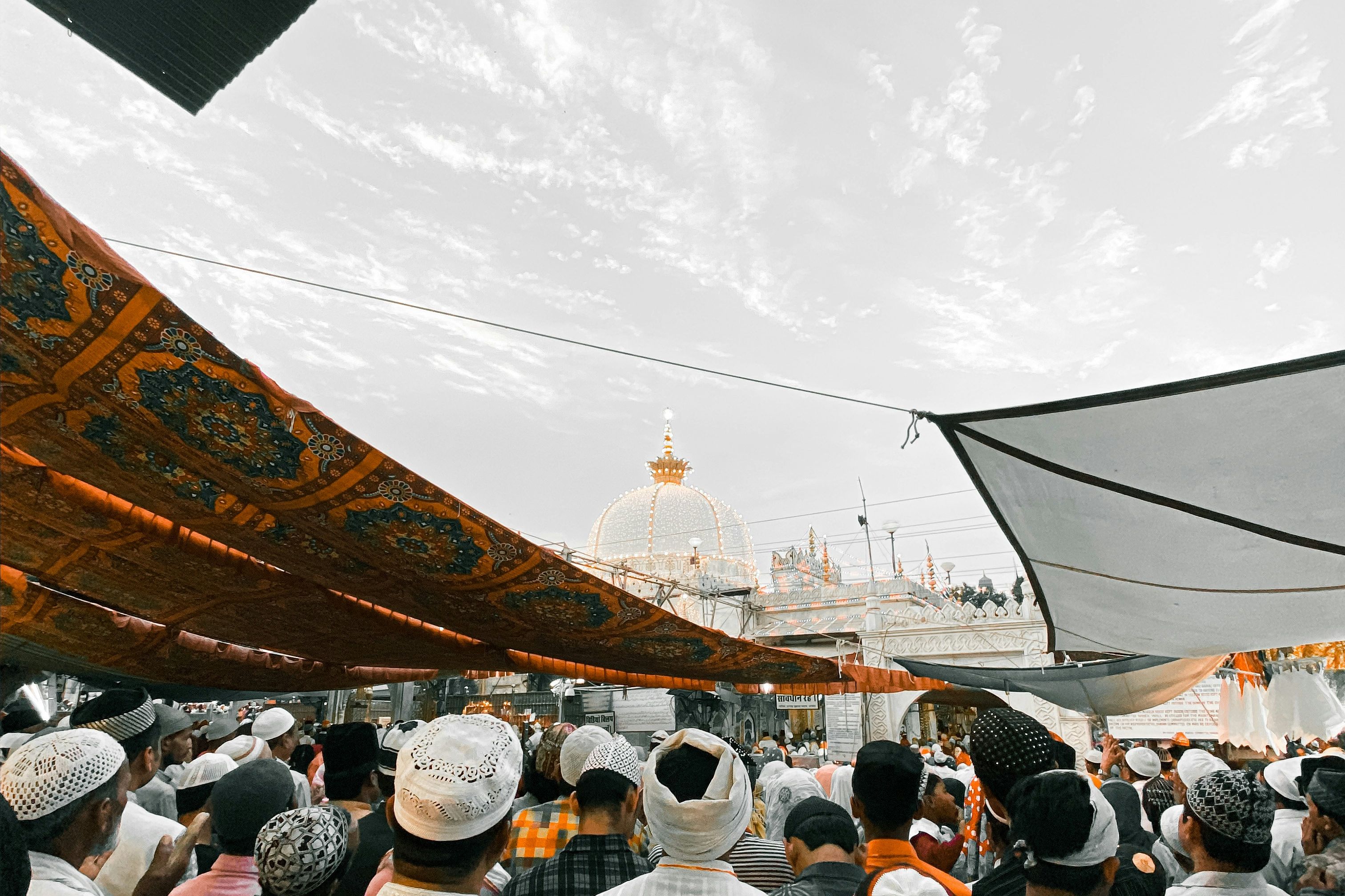 a group of people entering the ajmer sharif dargah