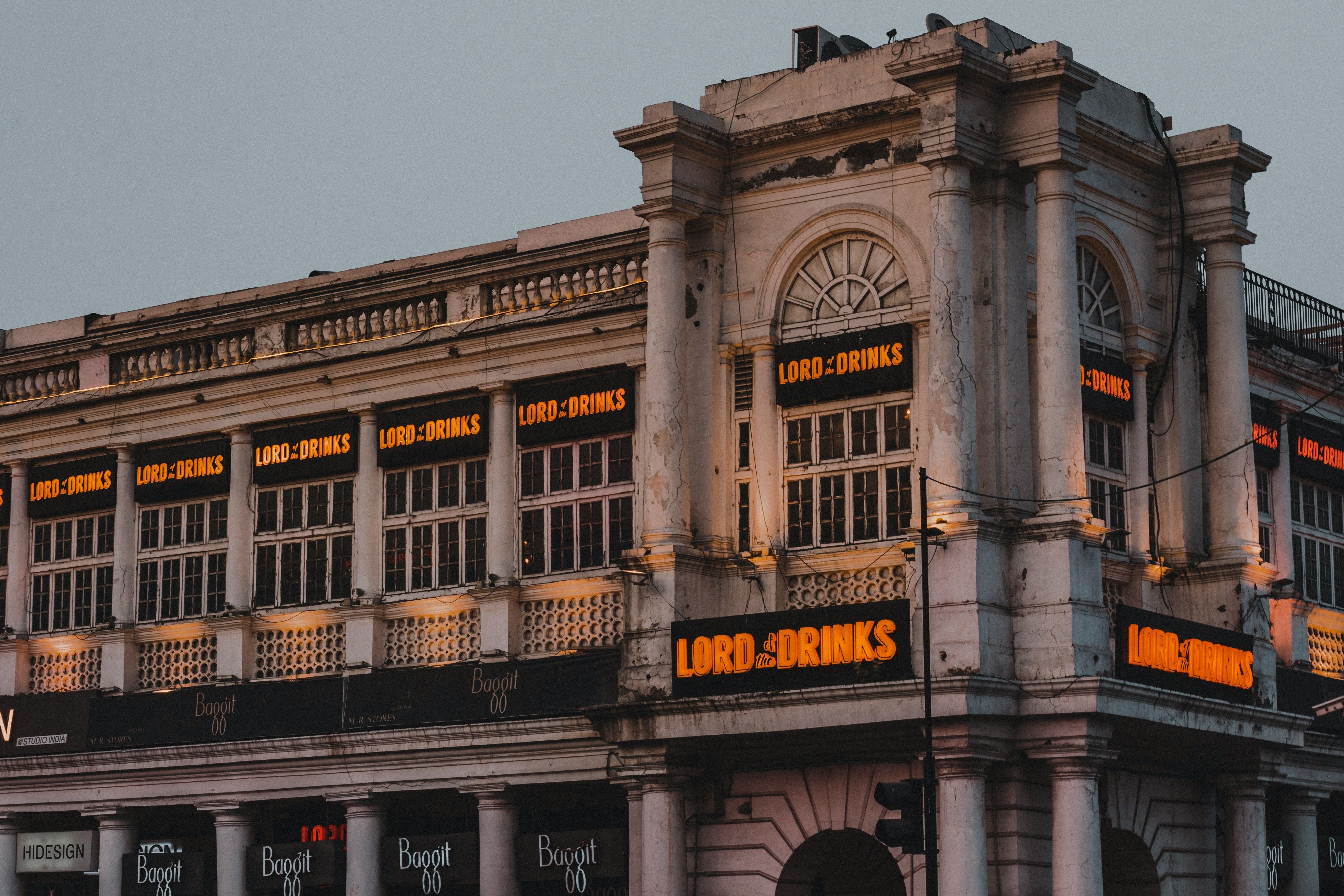 a large white building at connaught place in new delhi during evening