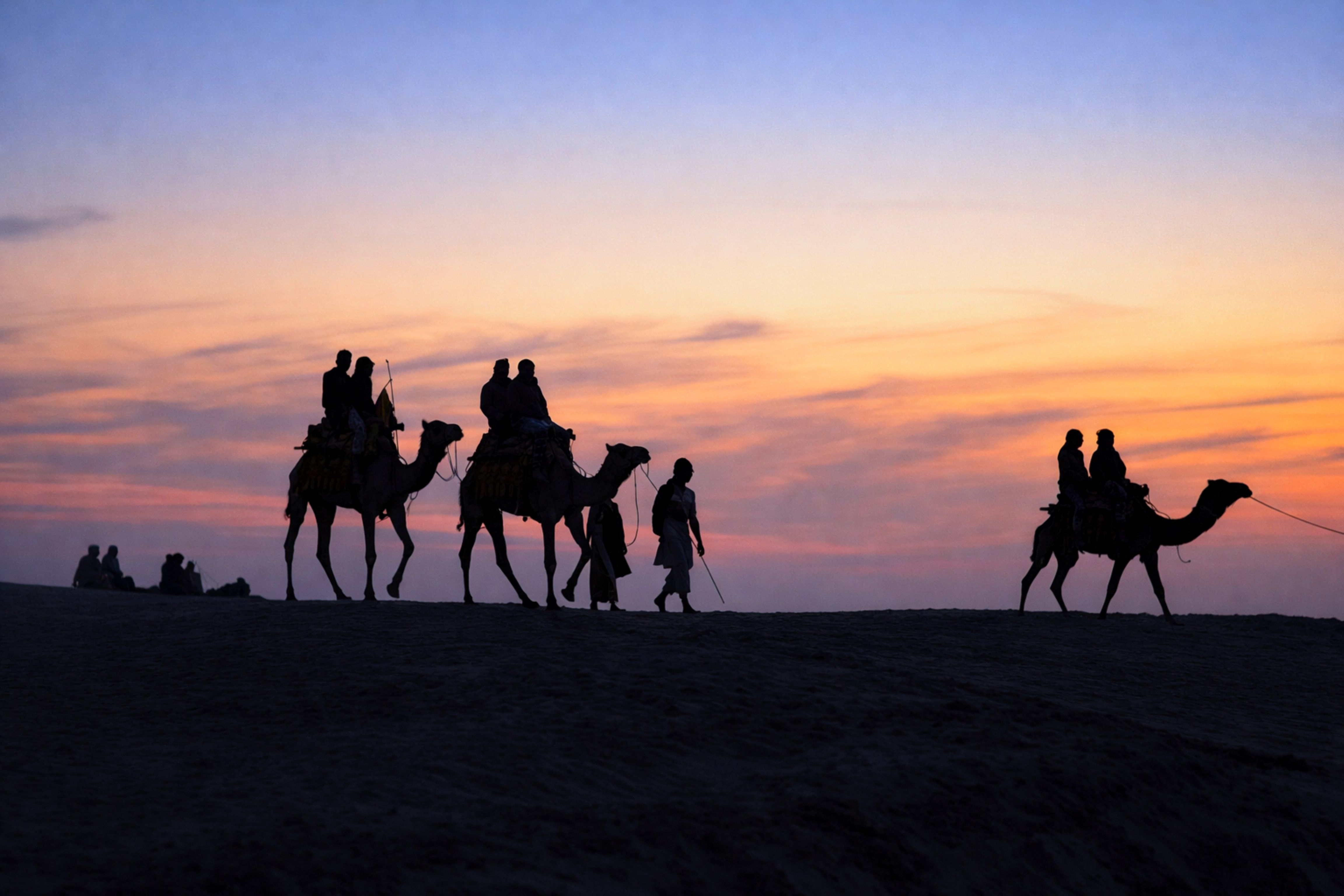 a scenic camel ride at sunset in the deserts of jaisalmer