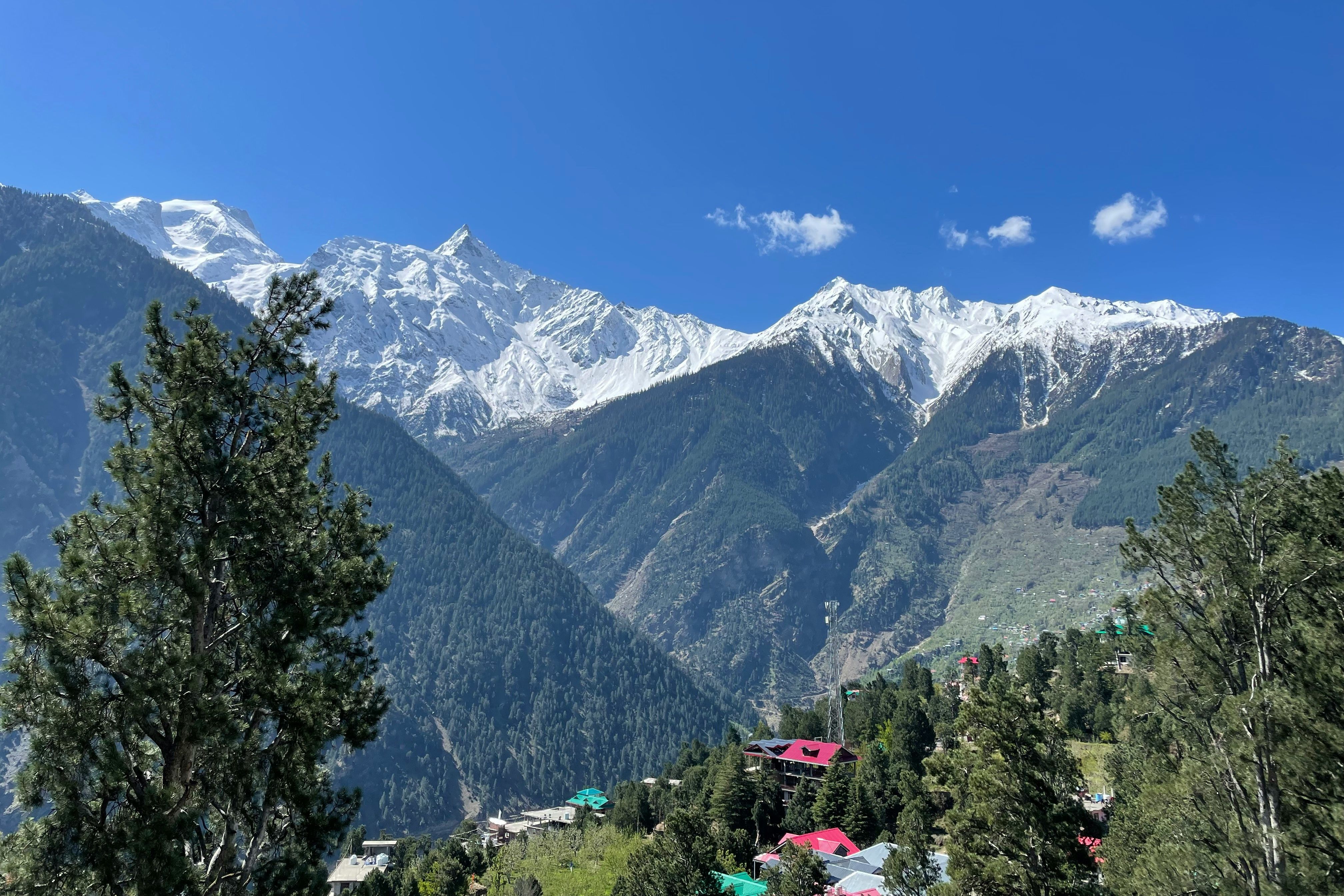 a view of mountain range with houses in the foreground in kinnaur valley