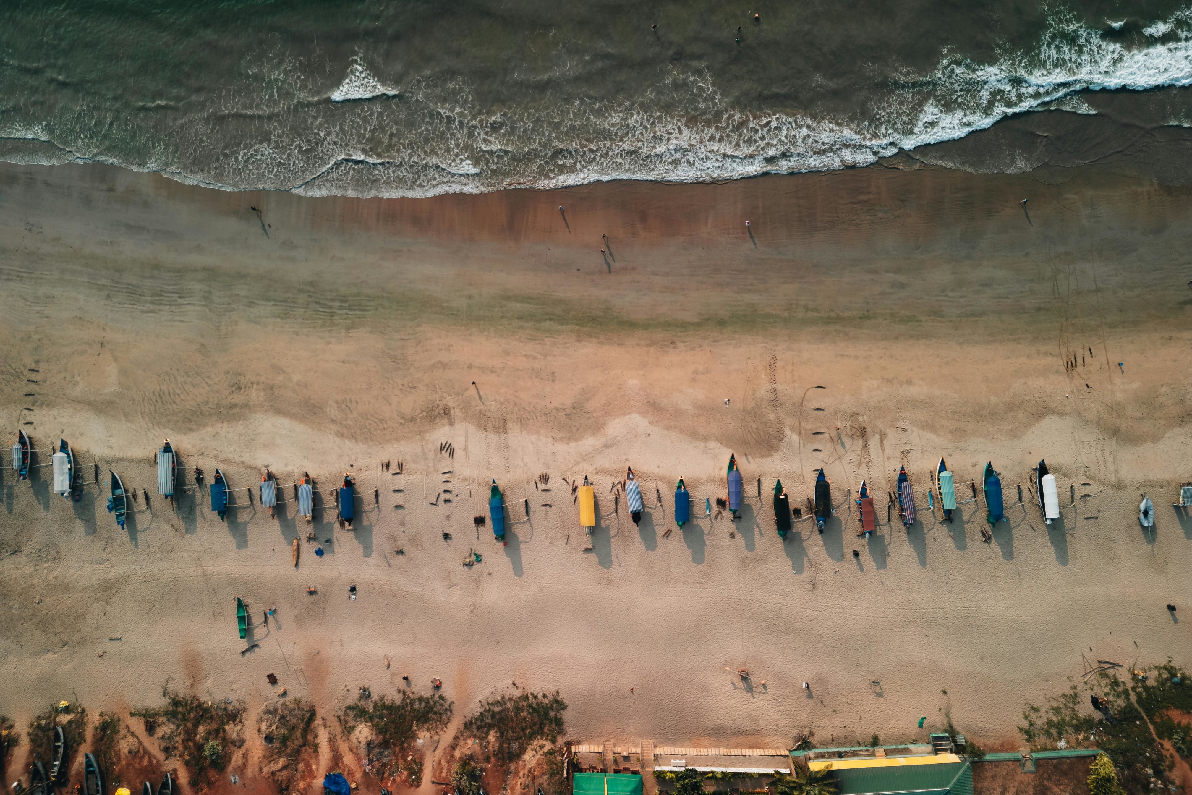 aerial view of colorful boats on the sandy calangute beach in goa