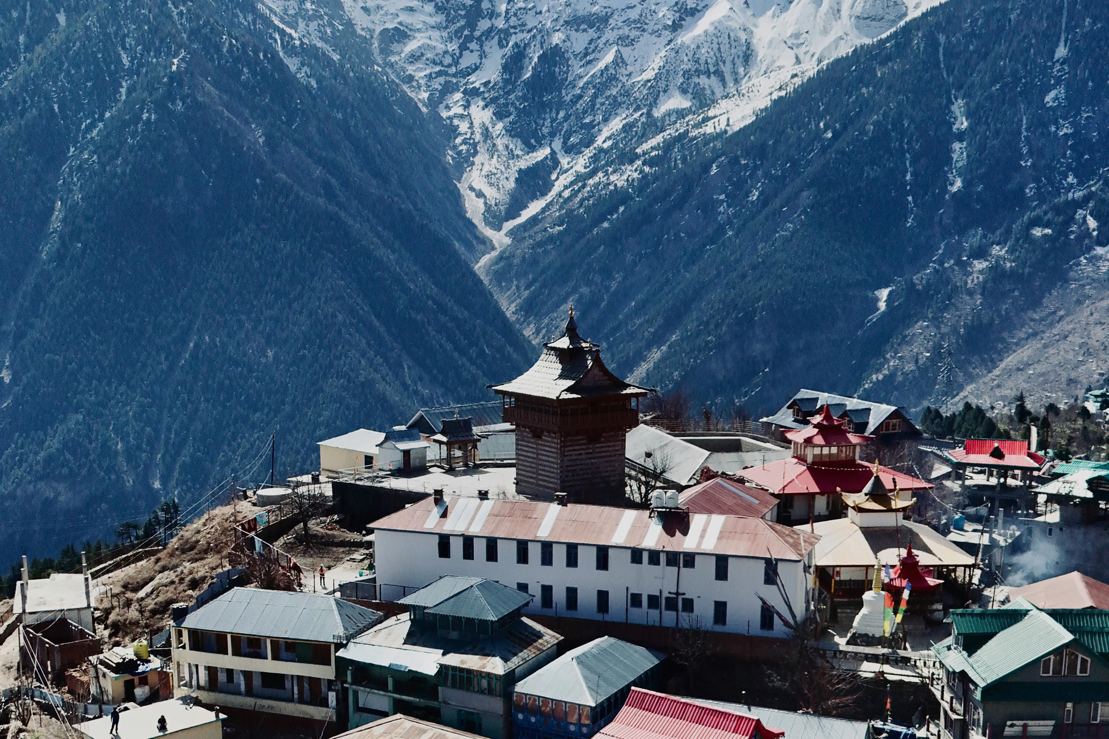 aerial view of kalpa village with snow capped mountains in the backdrop