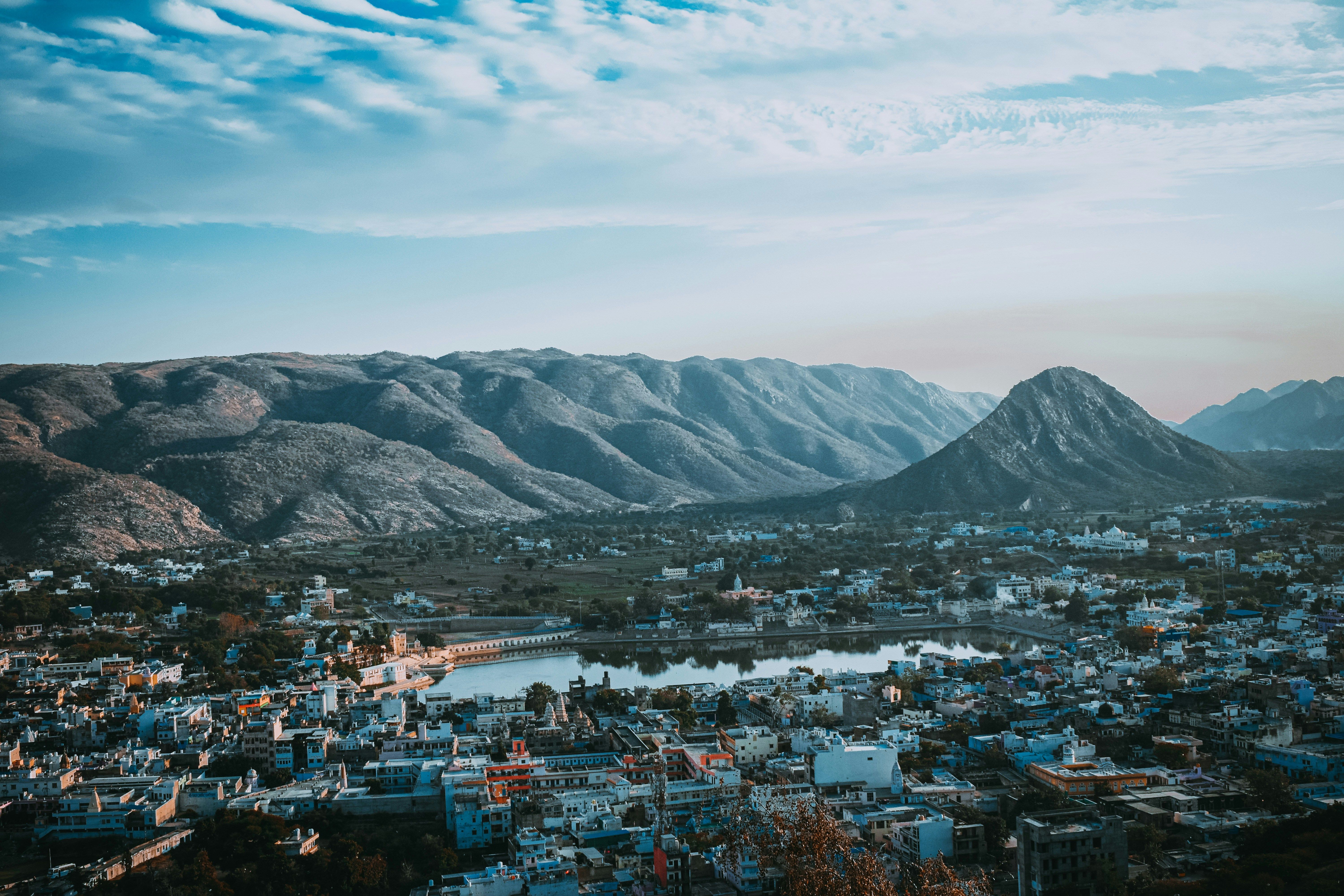 aerial view of pushkar city near lake and mountain during daytime