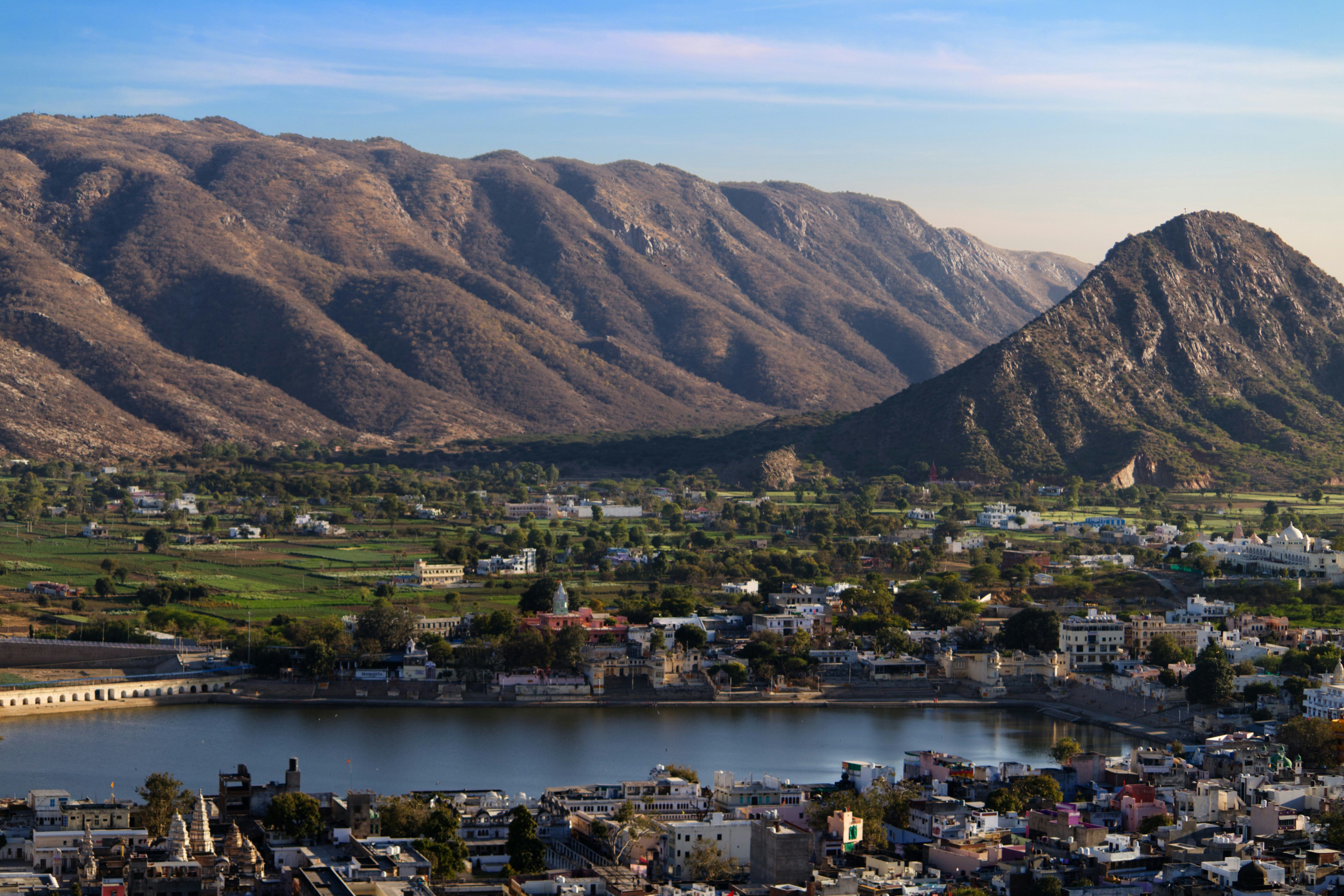 aerial view of pushkar city near lake and mountain during daytime