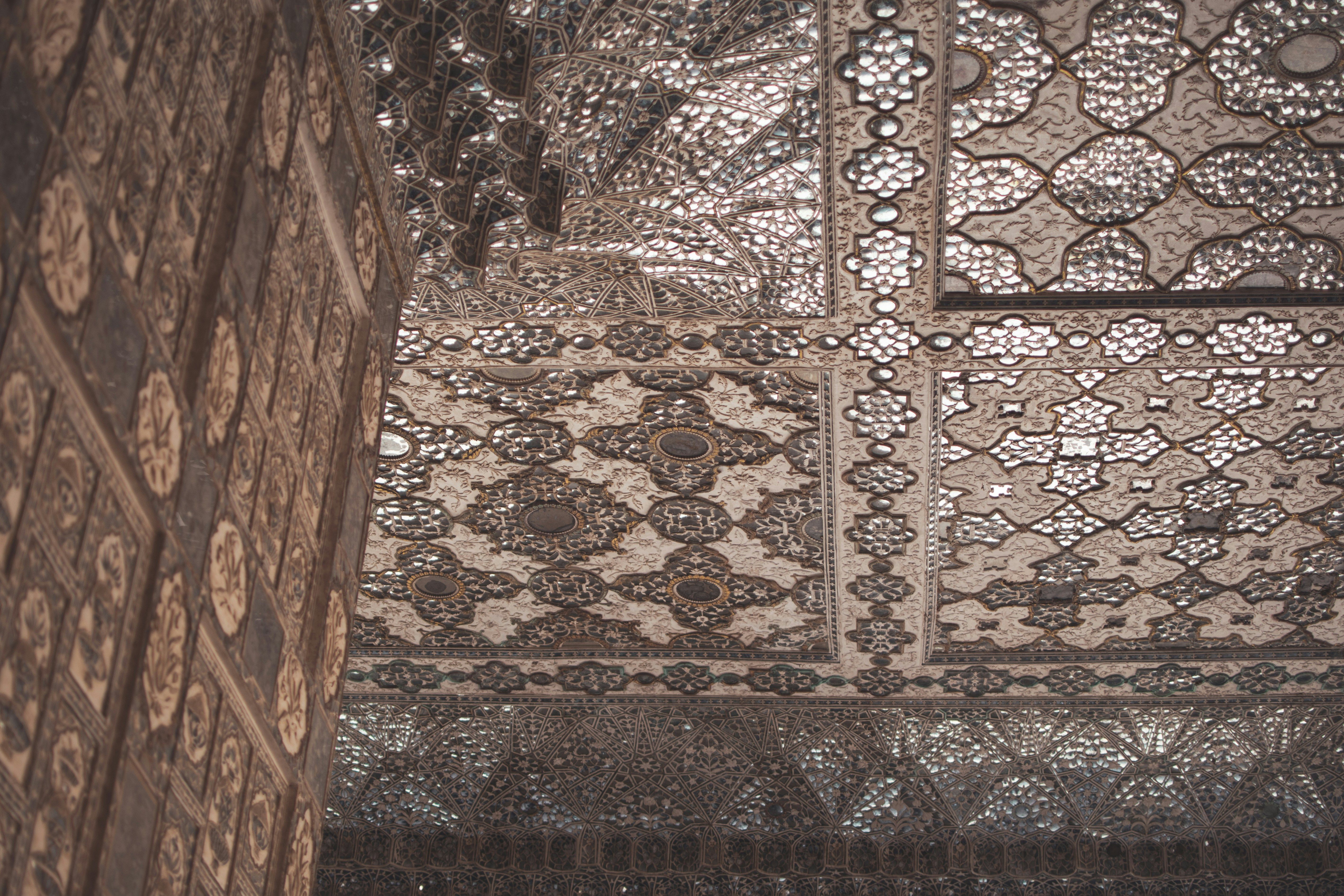 an intricately designed seesh mahal at amber fort jaipur