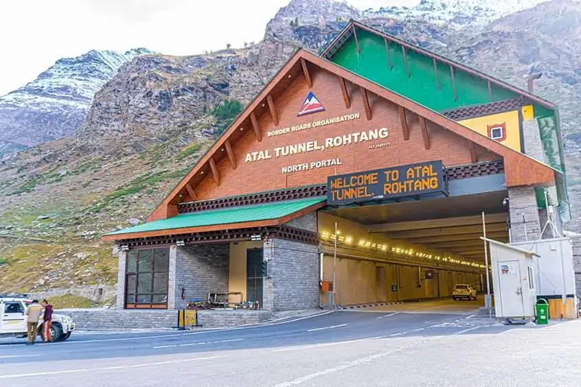 entrance at the south portal of atal tunnel with green coloured mountains in the backdrop