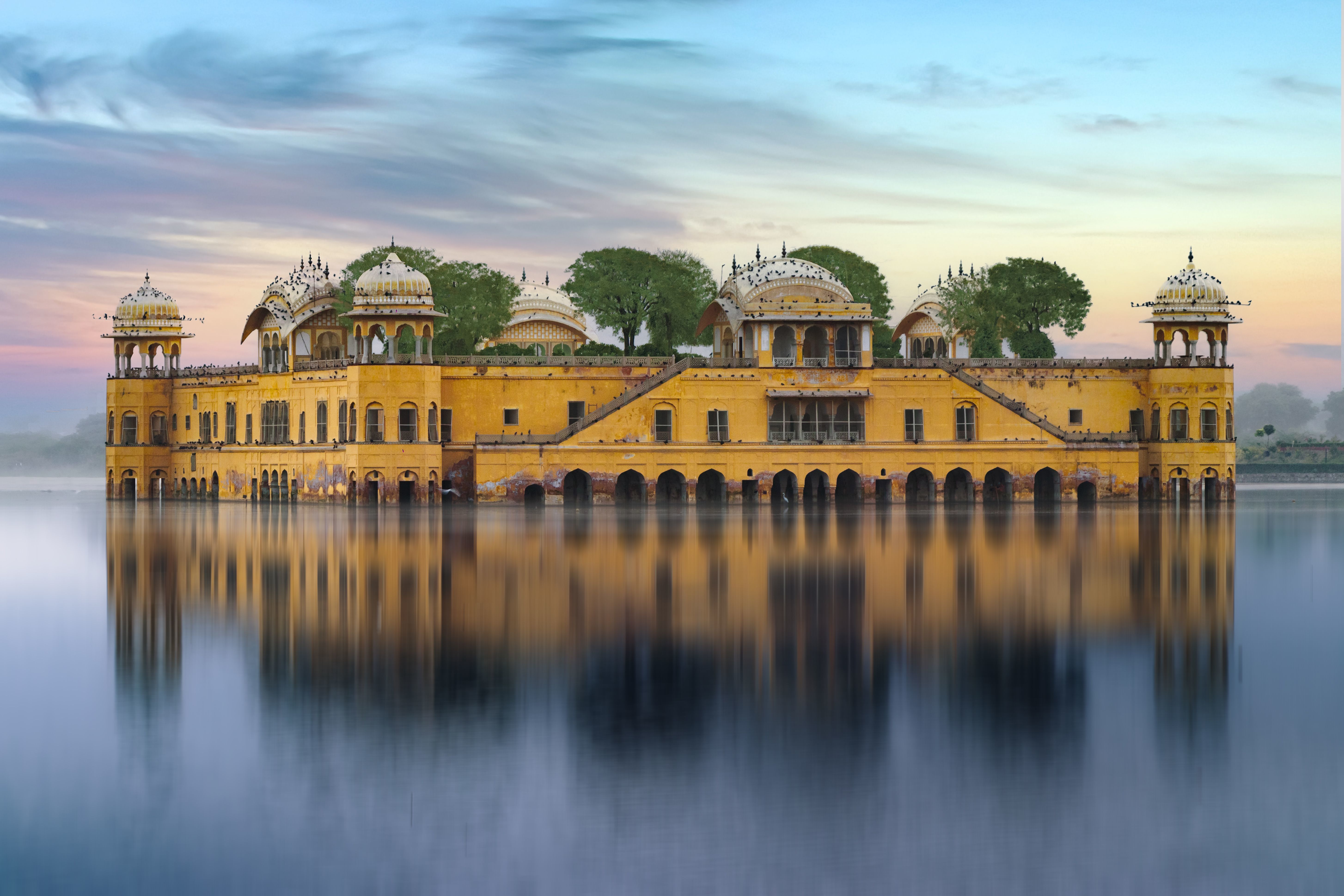 beautiful view of jal mahal palace reflecting on man sagar lake at sunset in jaipur