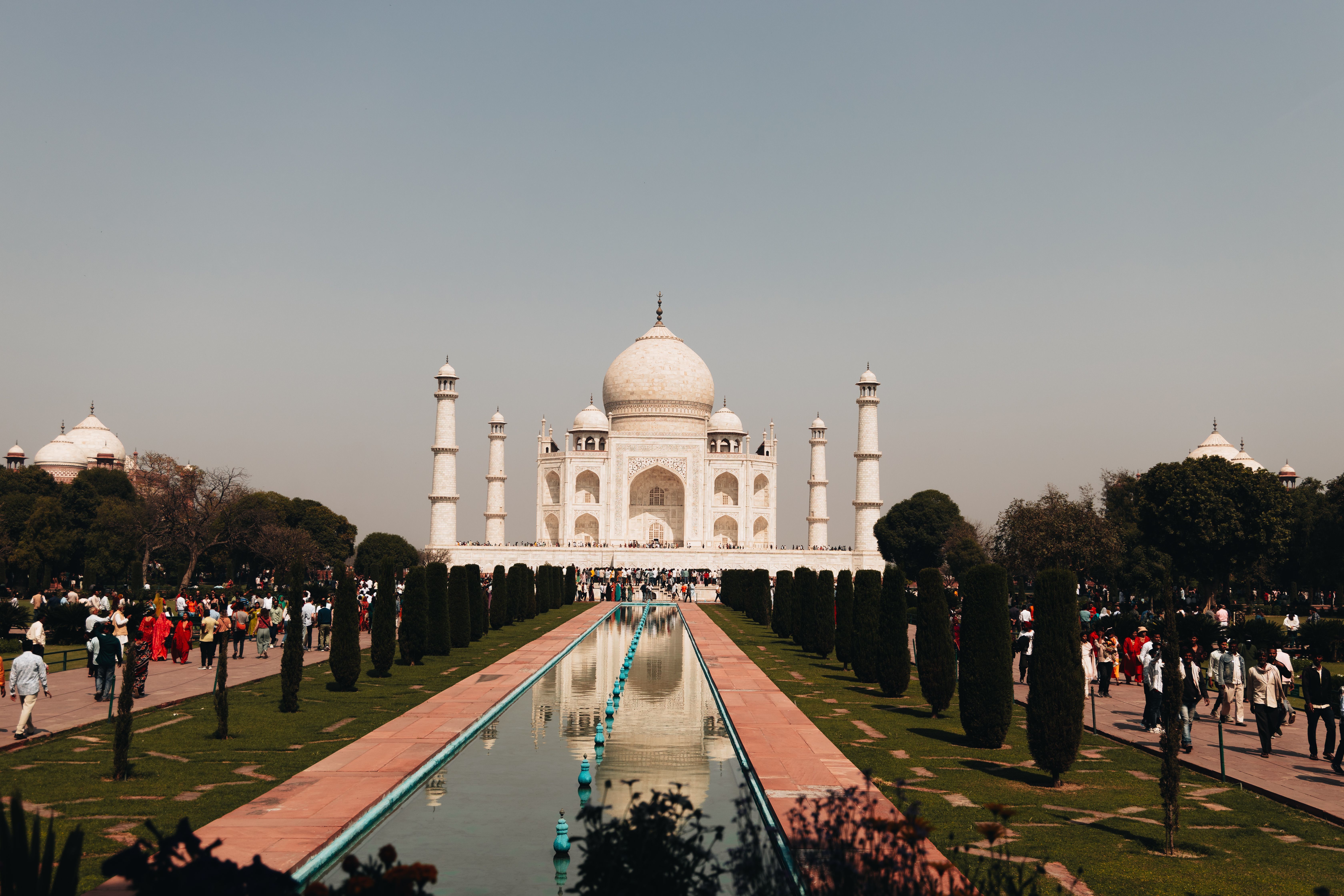 beautiful view of the taj mahal with tourists around it