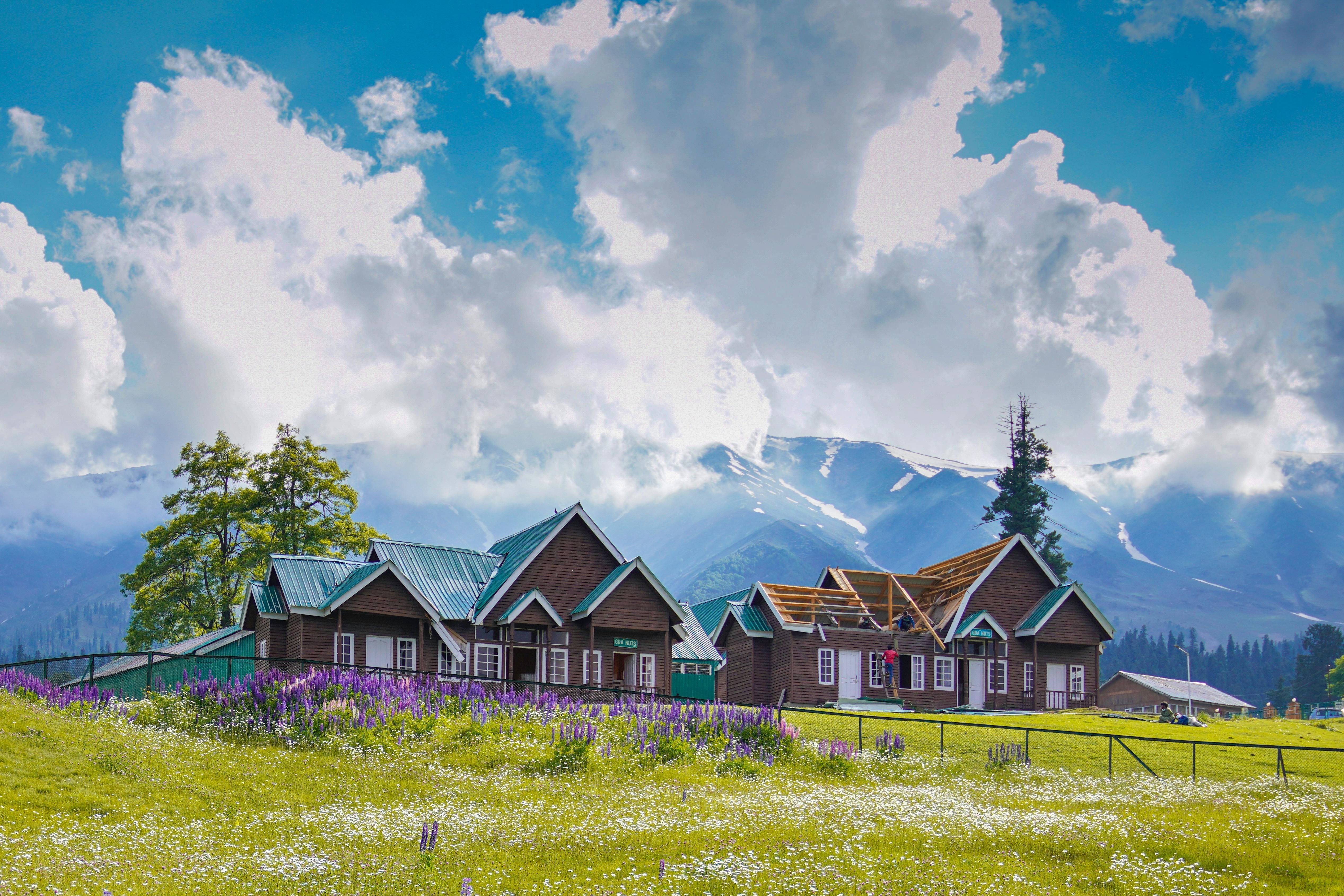 beautiful wooden houses on green field in gulmarg