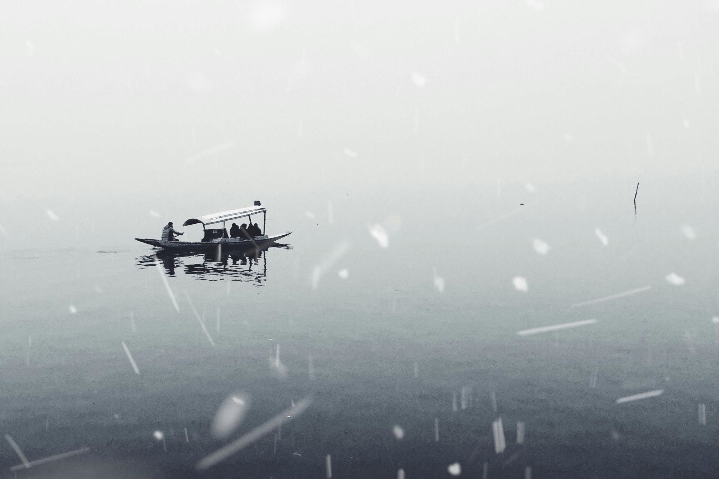 boat in the dal lake during snow