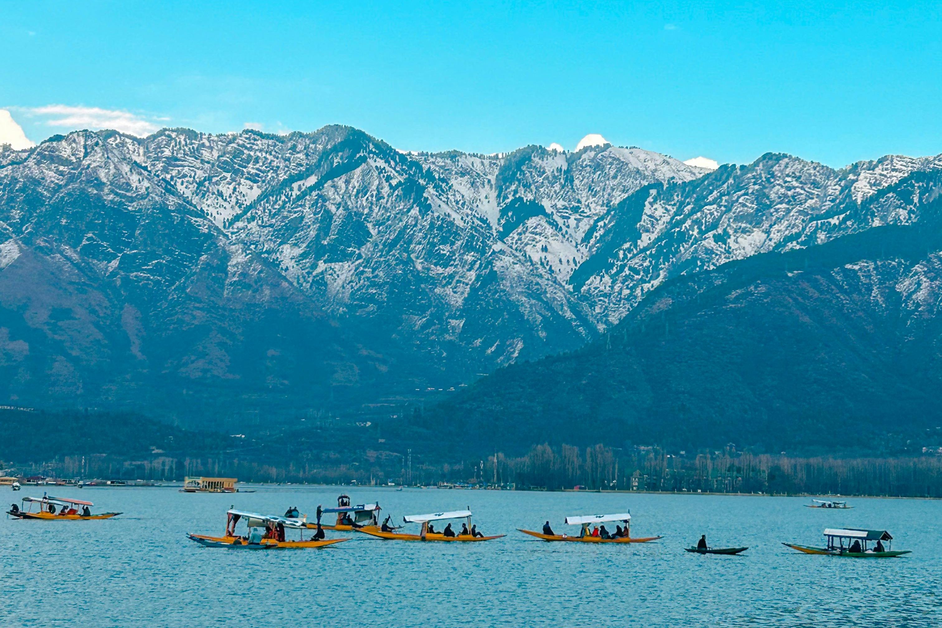 shikara boats in dal lake in a mountain valley in srinagar