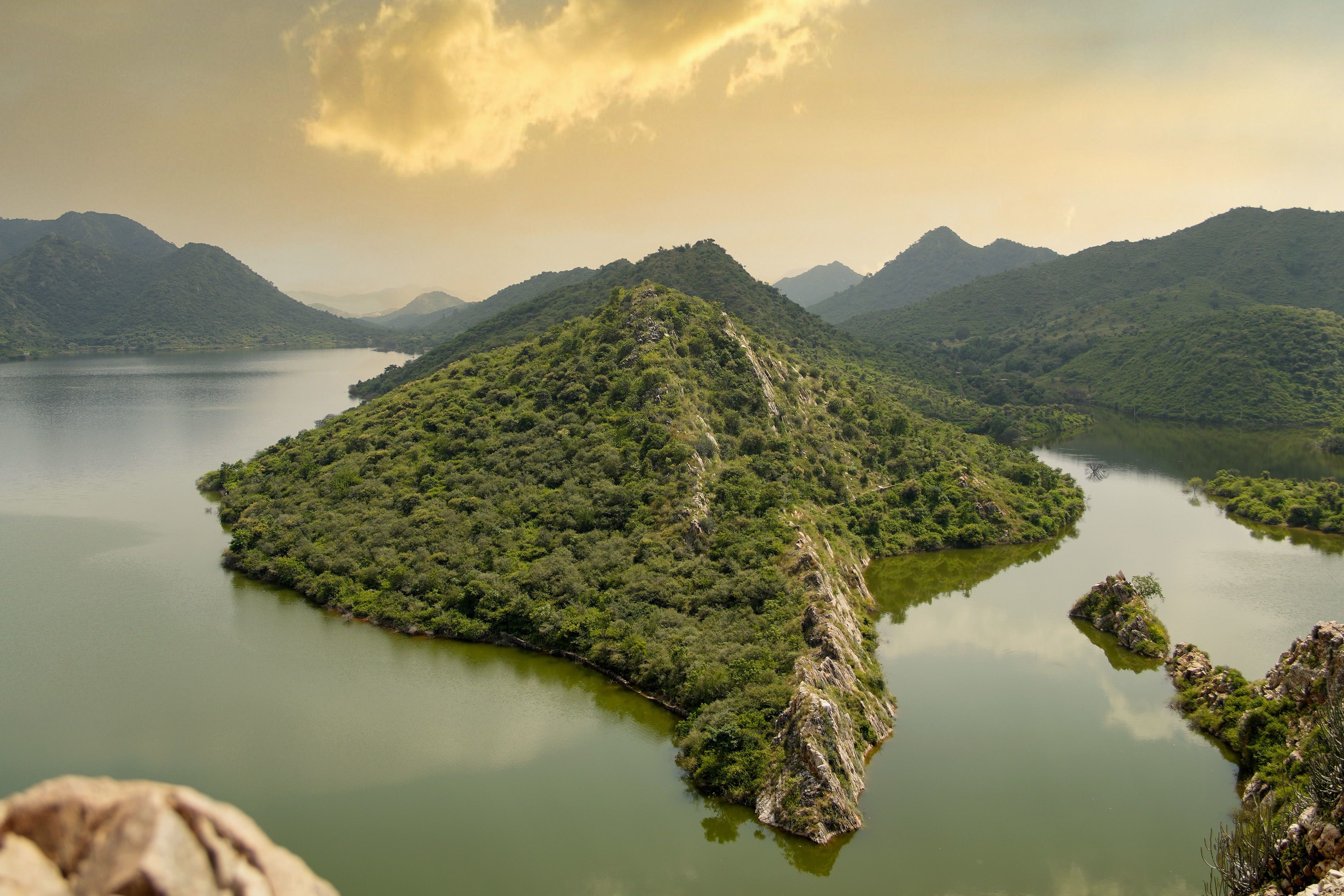 breathtaking landscape showing lush aravalli hills and serene lake in udaipur