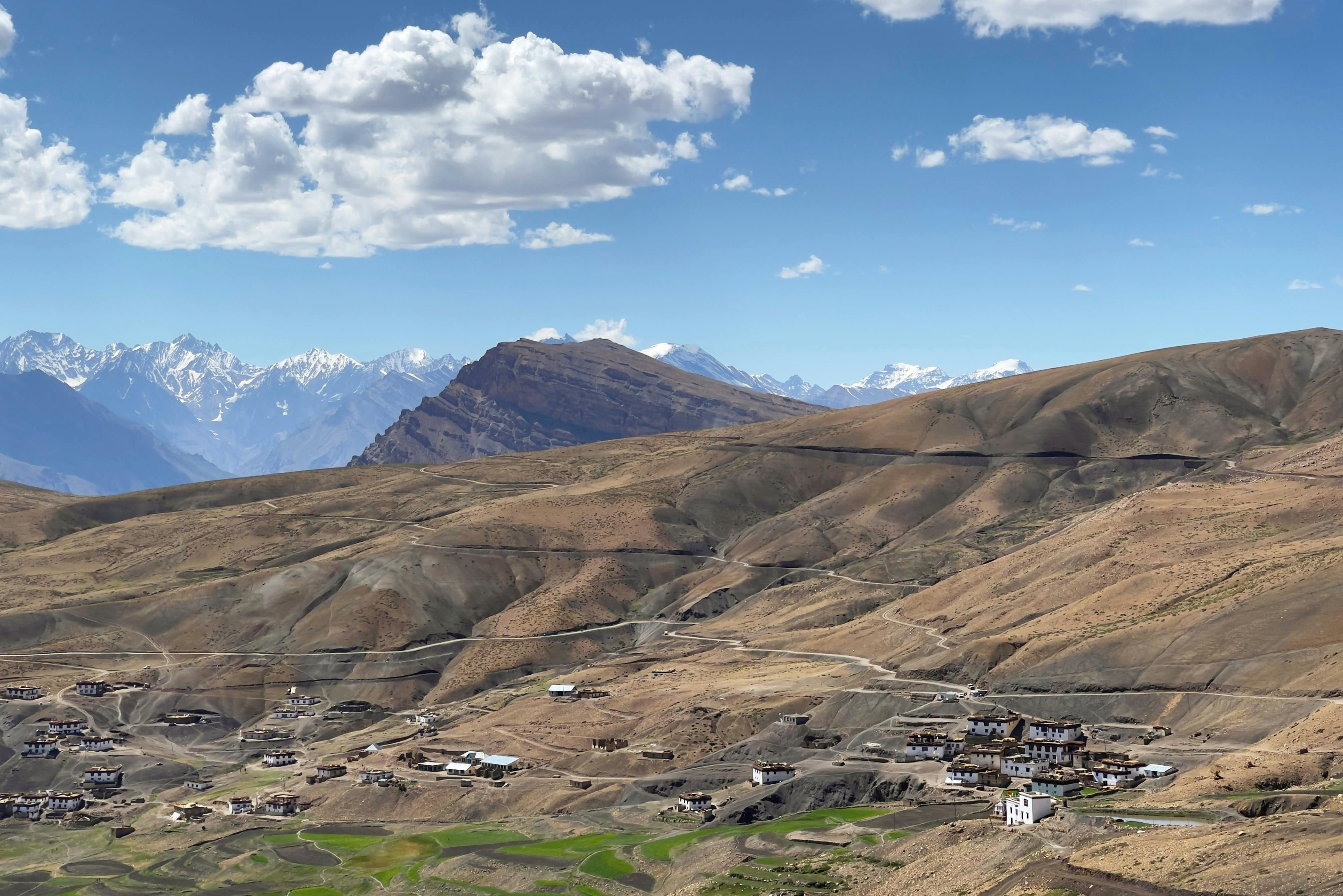 brown mountains under blue sky and white clouds in kibber village in spiti valley