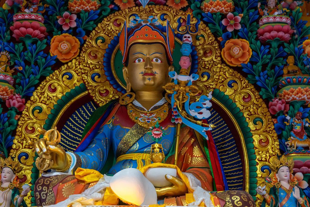 a close up view of the idol of padmasambhava inside the gue monastery