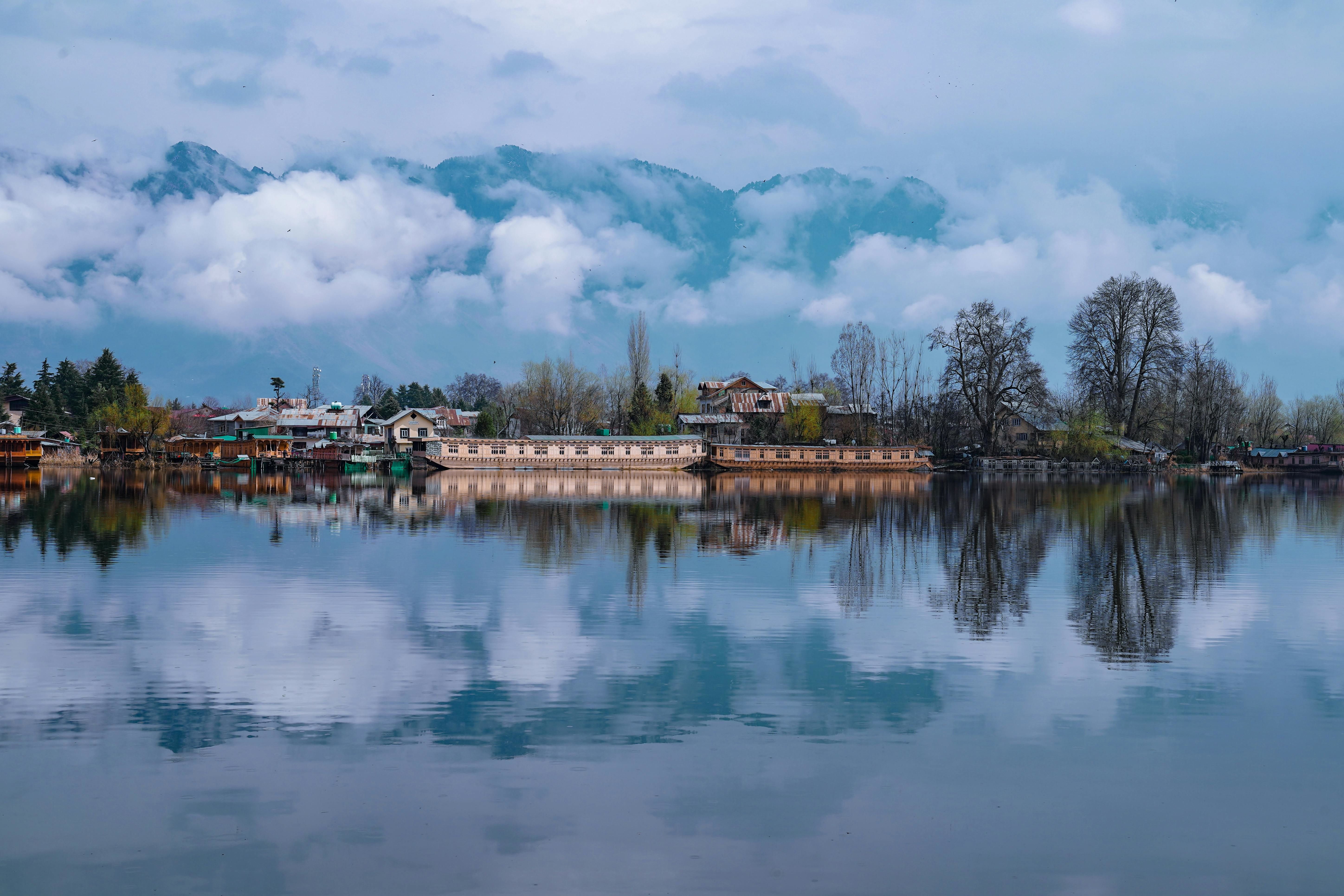 houseboat reflection in the calm waters of dal lake in srinagar