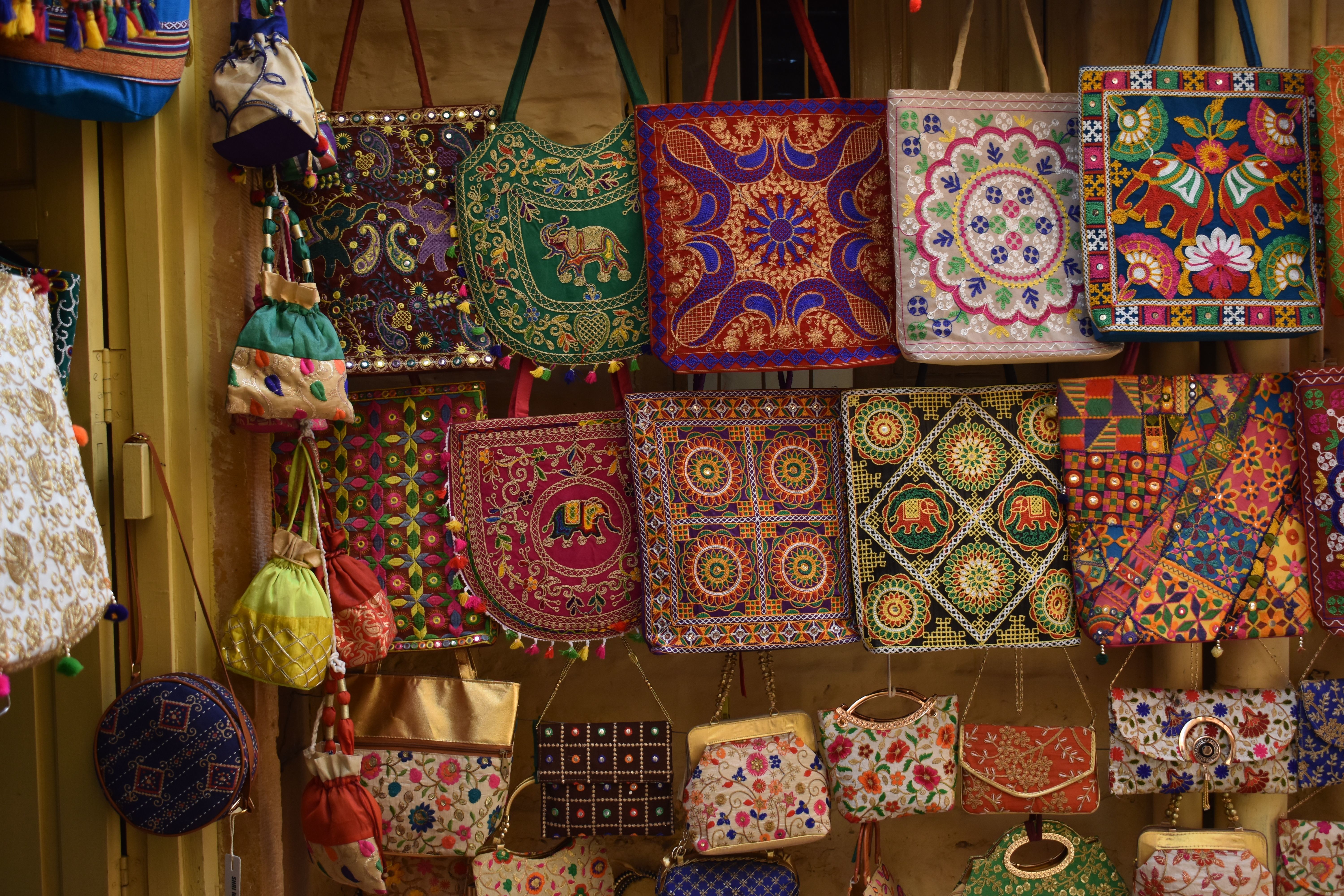 colorful embroidered handbags on display at johari bazaar