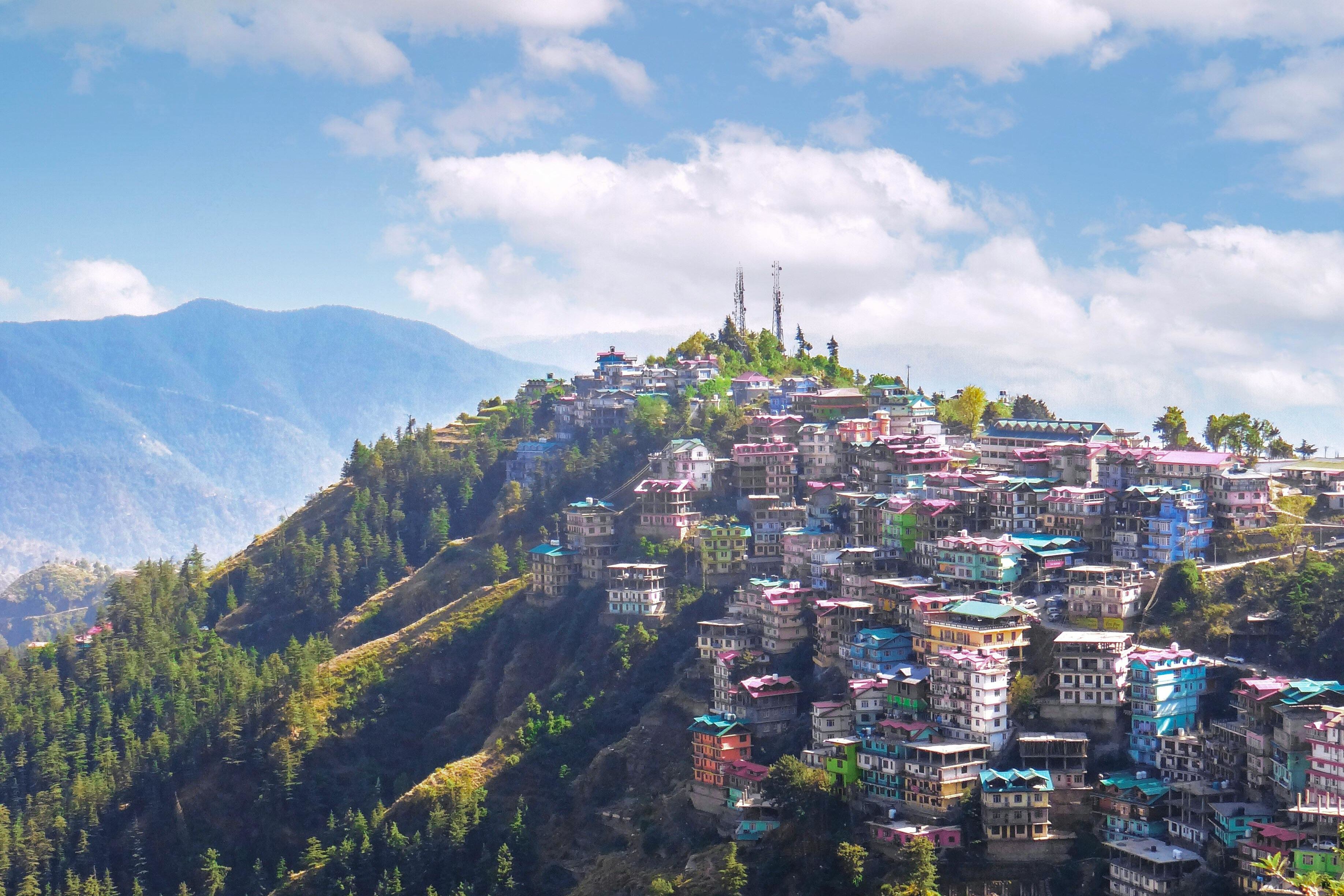 colorful houses on the mountain under blue sky in kufri