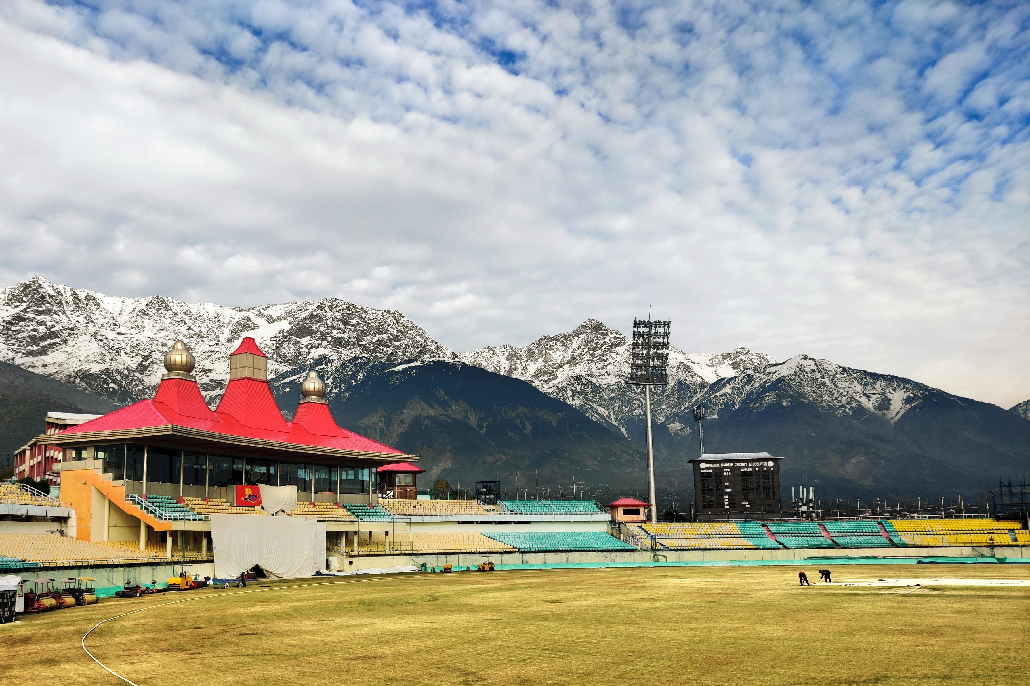 dharamshala cricket stadium with snow covered mountains in the backdrop
