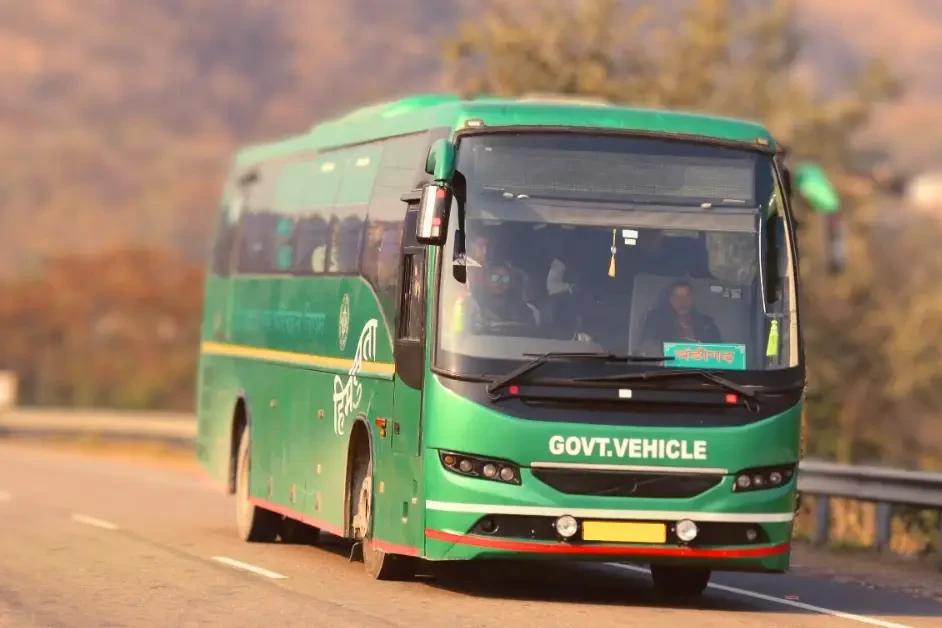 a green volvo bus plying in between delhi and dharamshala