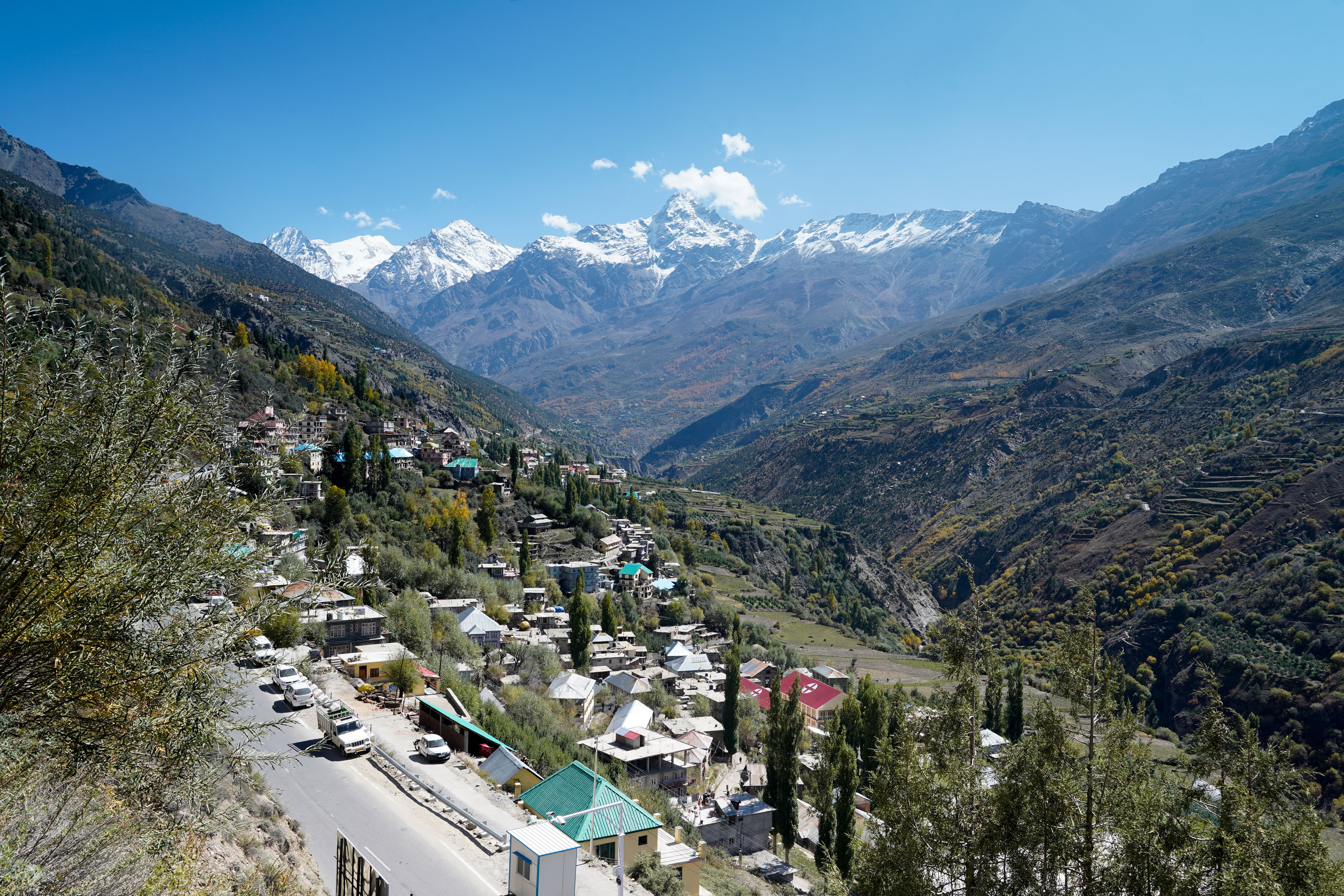 houses alongside a road in keylong town in himachal pradesh