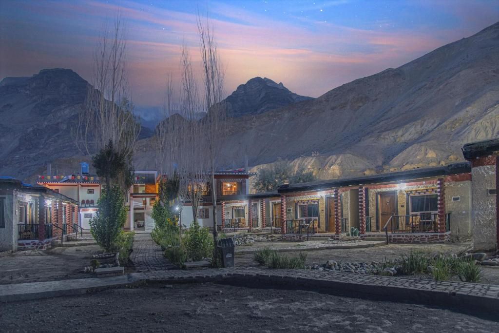 front view of hotel echor mud huts at tabo
