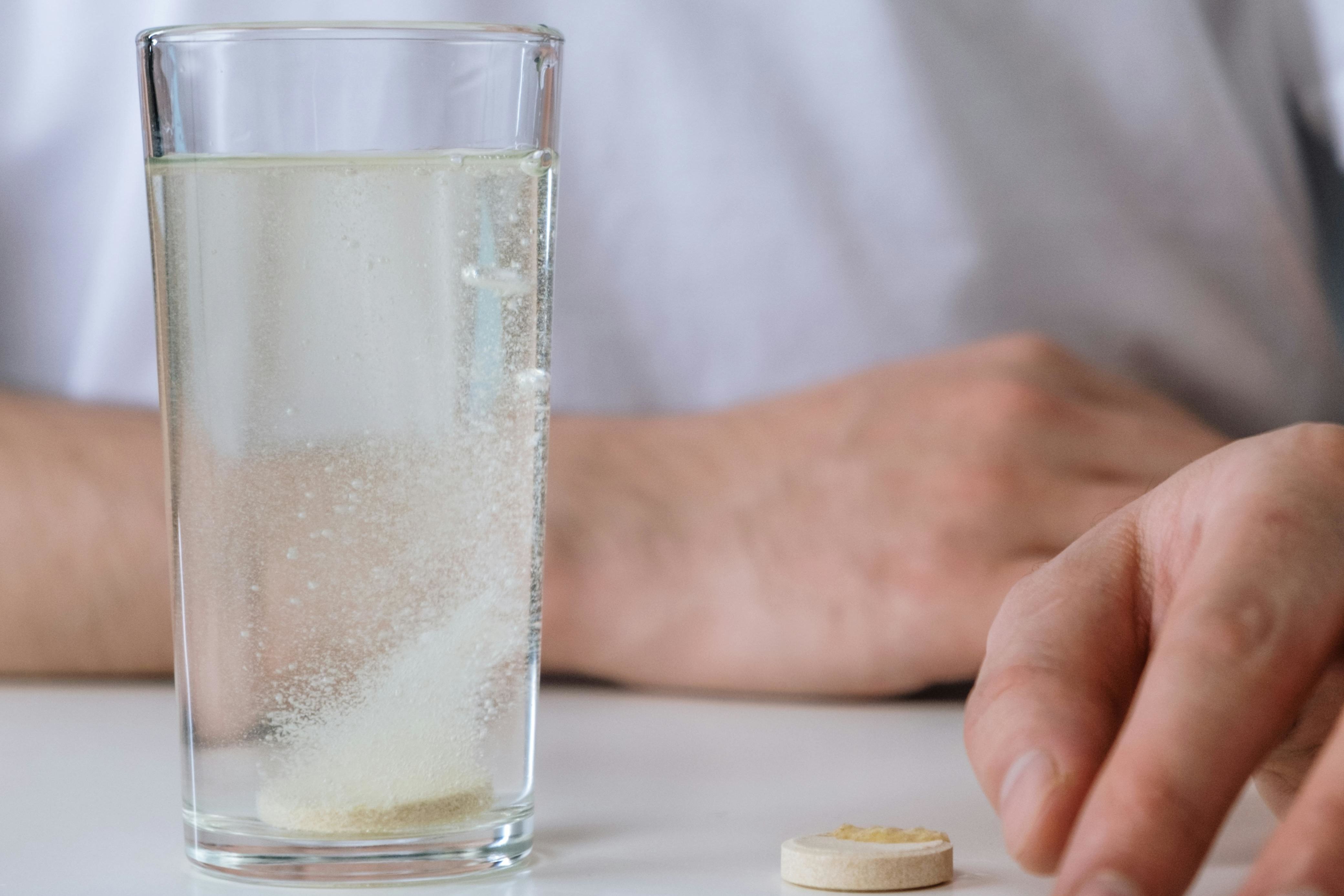 a tablet dissolving in a glass of water