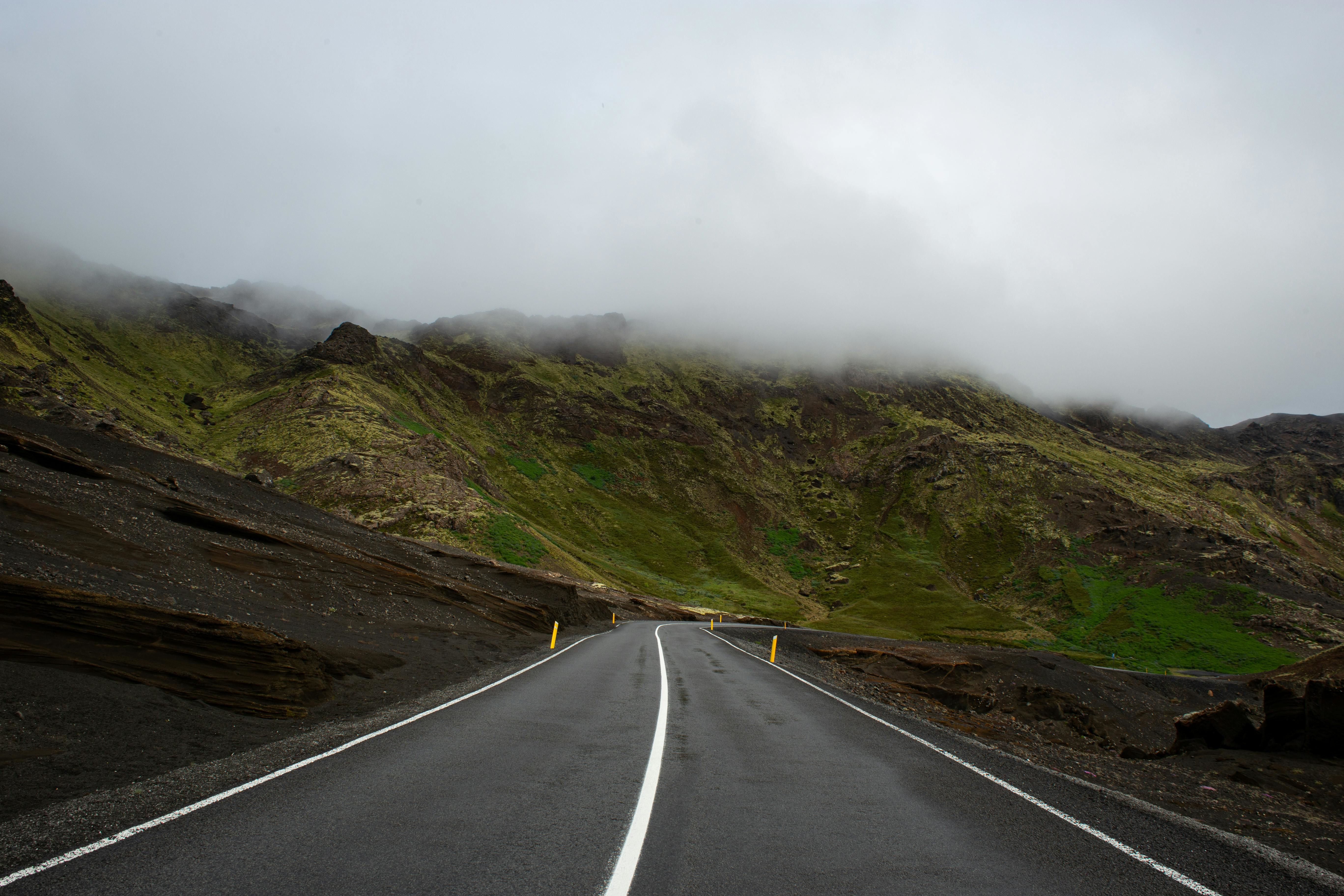 empty road along the mountain on a rainy day