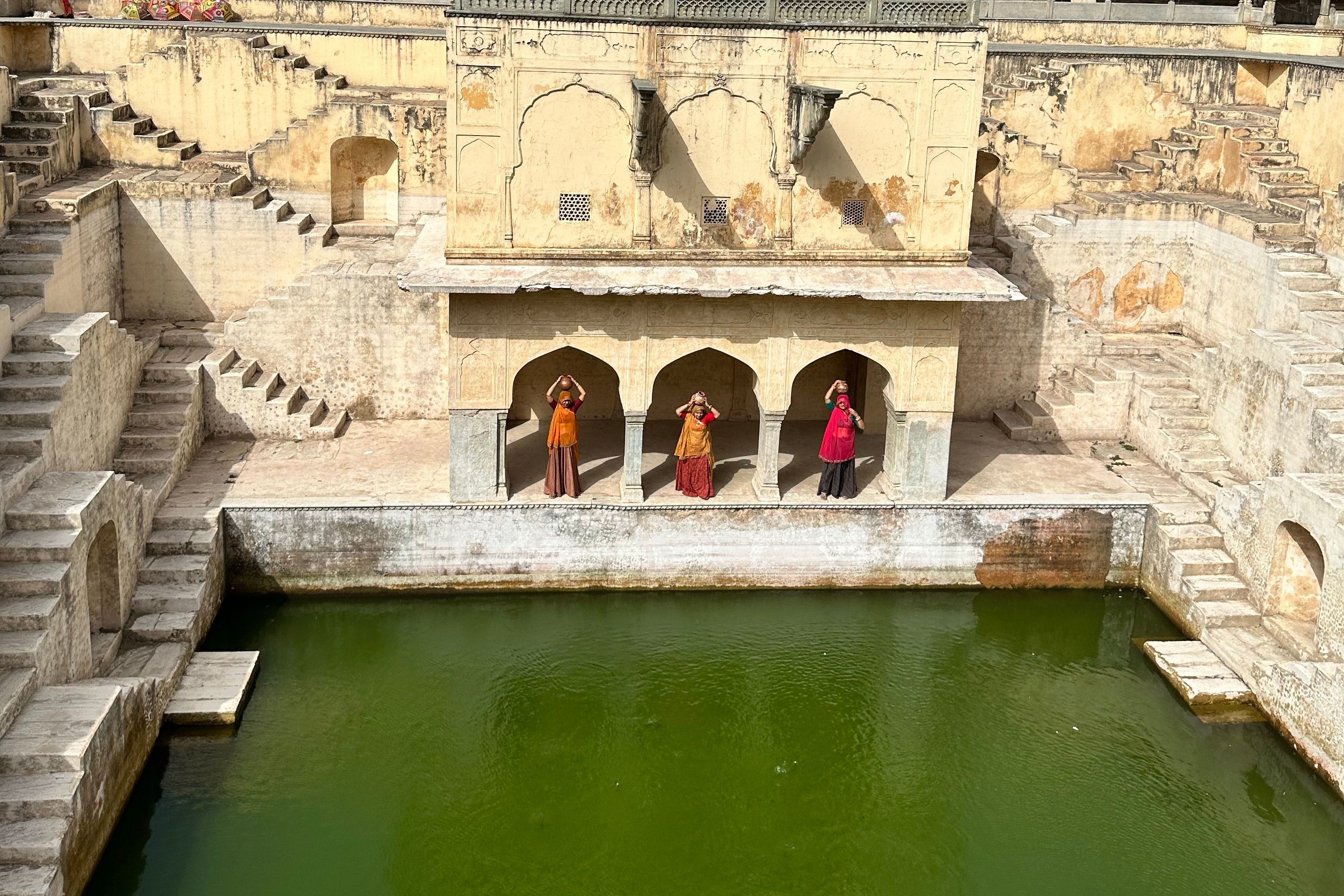 a historic stepwell with reflective water in bundi in rajasthan