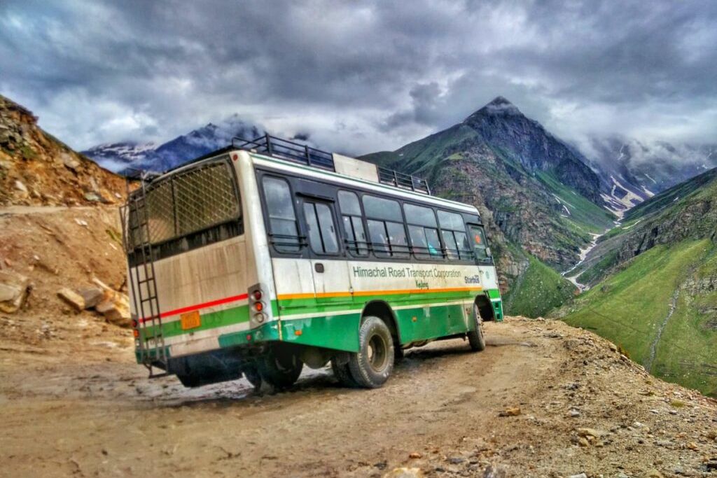hrtc bus travelling on winding mountains road of himachal pradesh