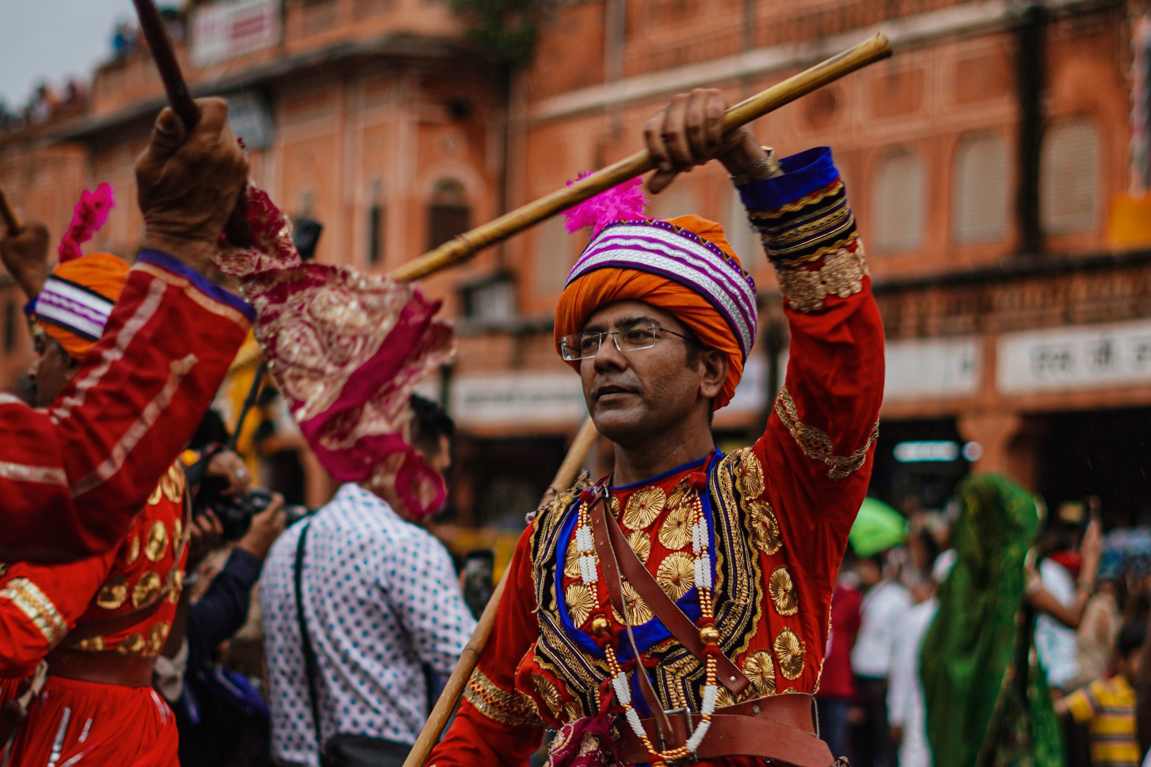 men in traditional rajasthani attire dancing at a cultural festival