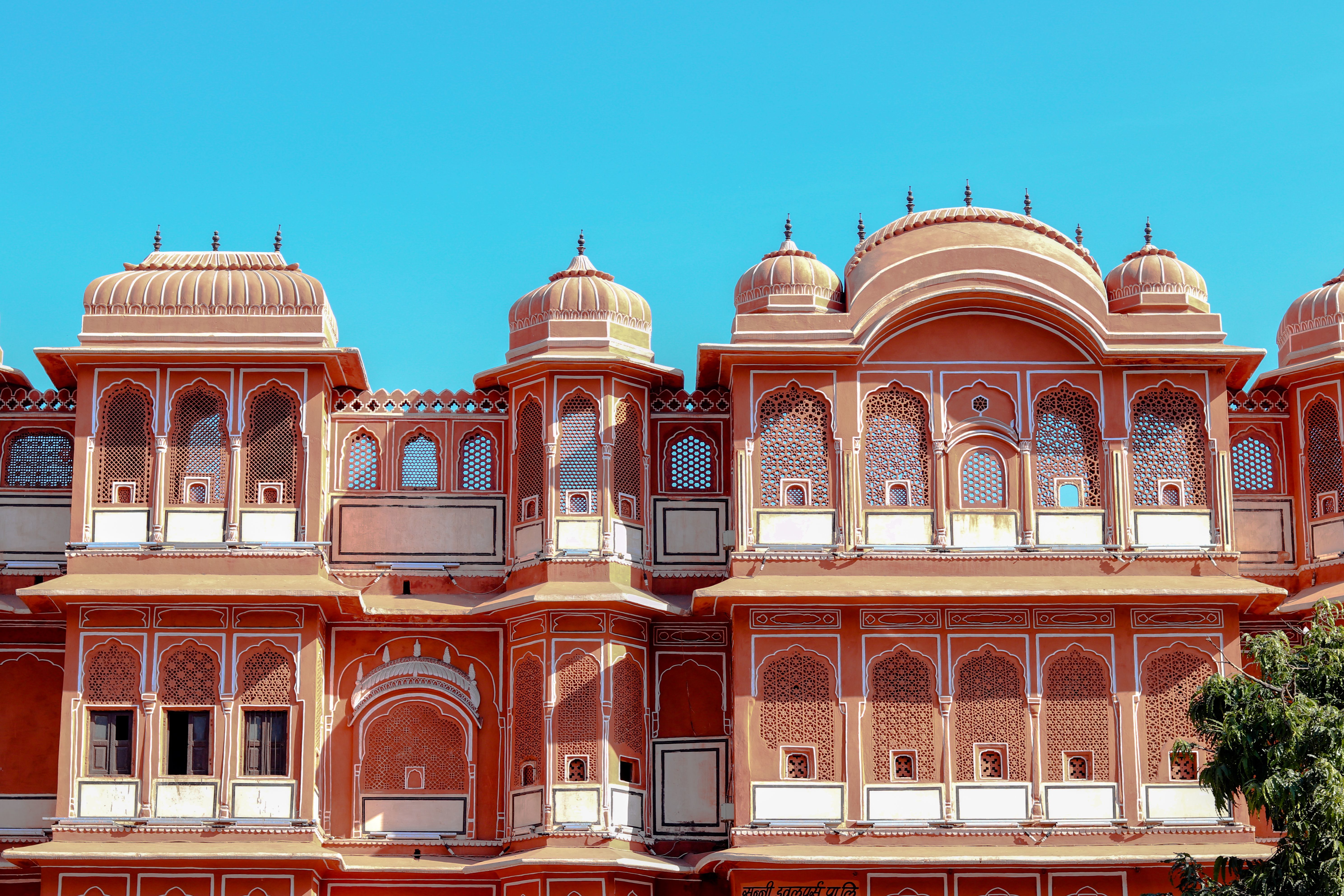 intricate architectural details of city palace in jaipur under a clear blue sky