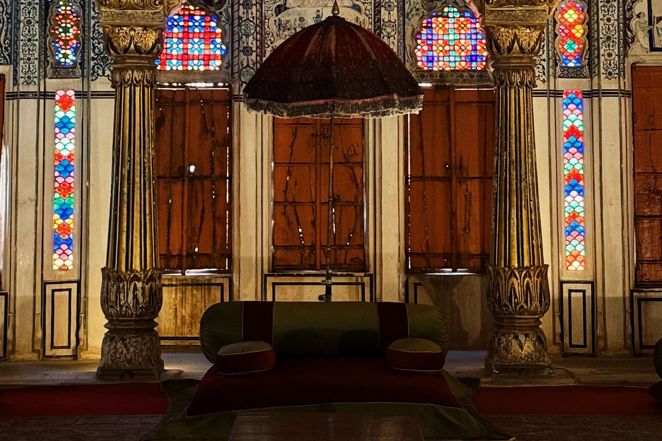 intricate architecture featuring vibrant stained glass and gold detailing in moti mahal in jodhpur