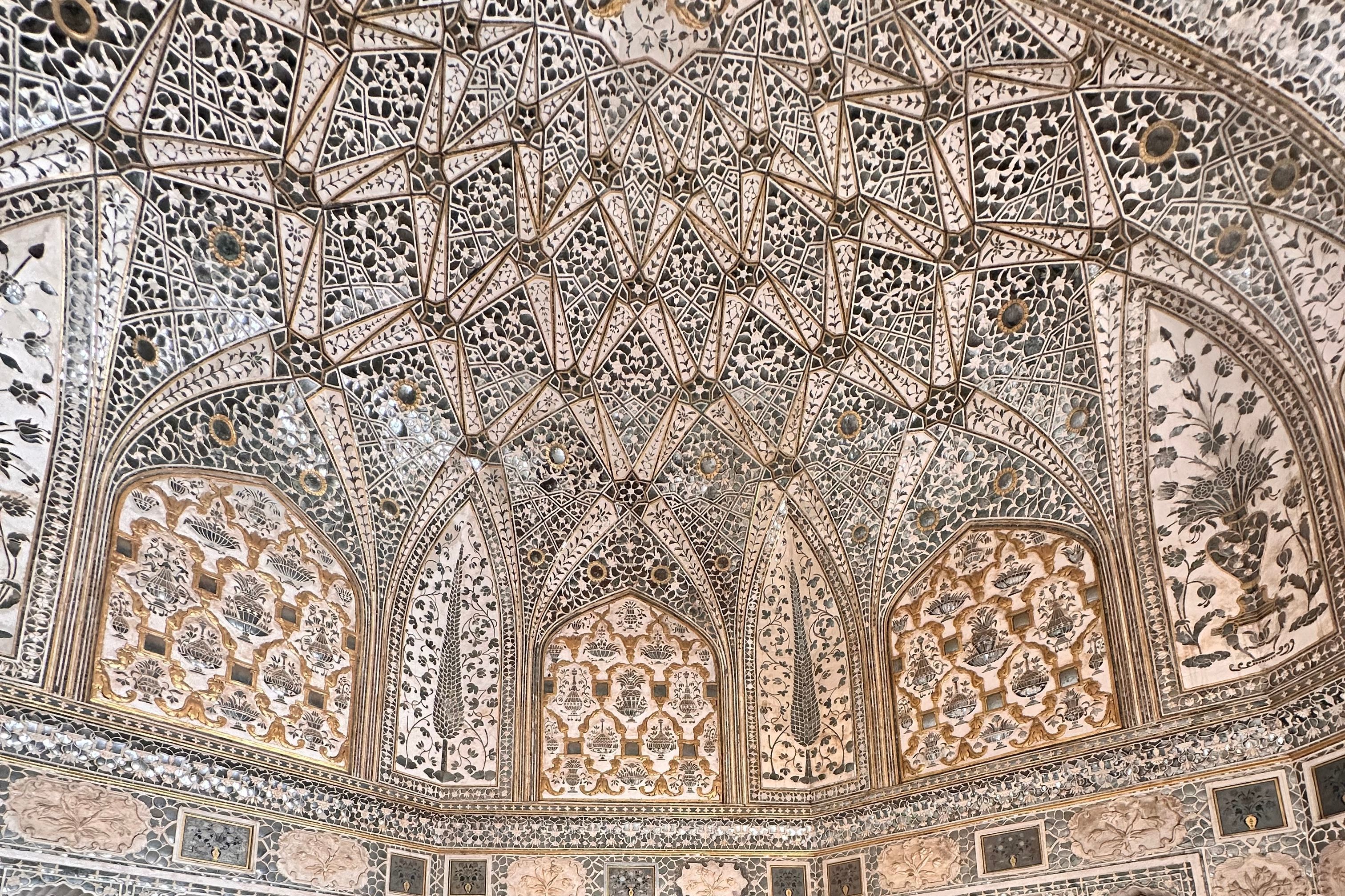 intricate mughal architecture in sheesh mahal inside of the amber fort in jaiupur
