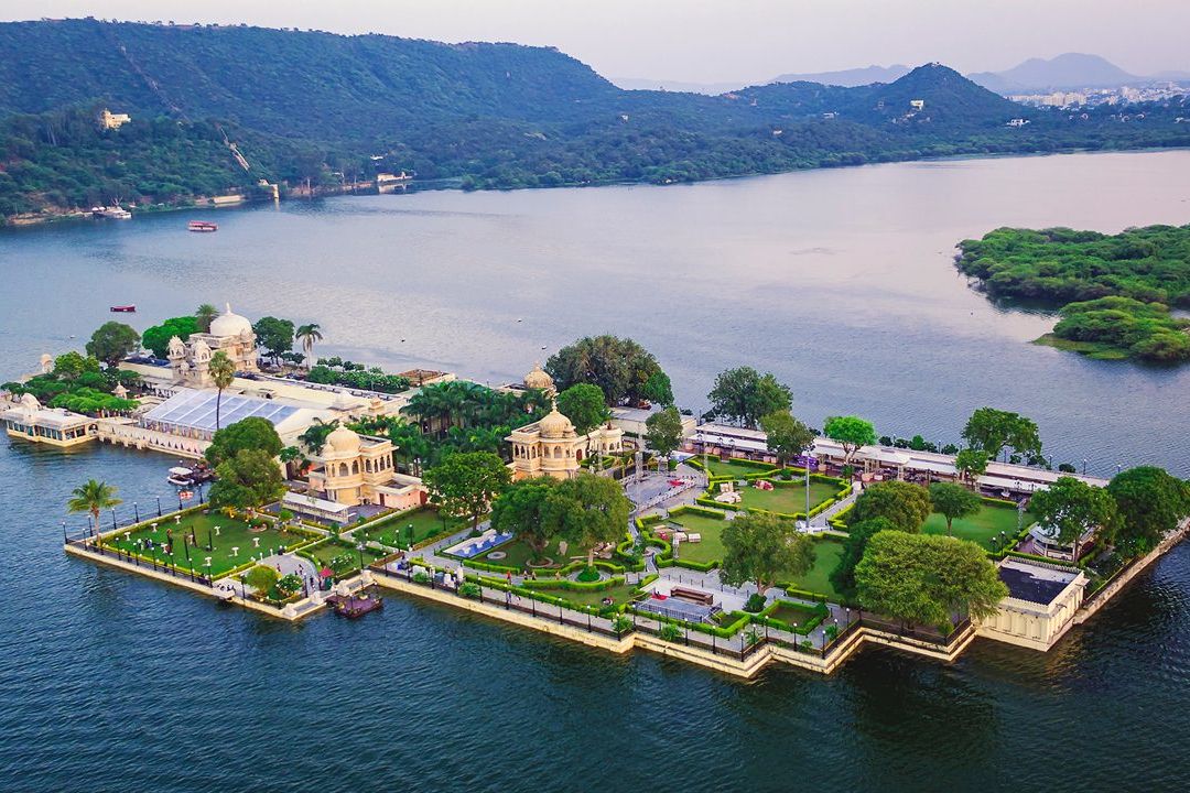 aerial view of jag mandir palace surrounded by a lake in udaipur