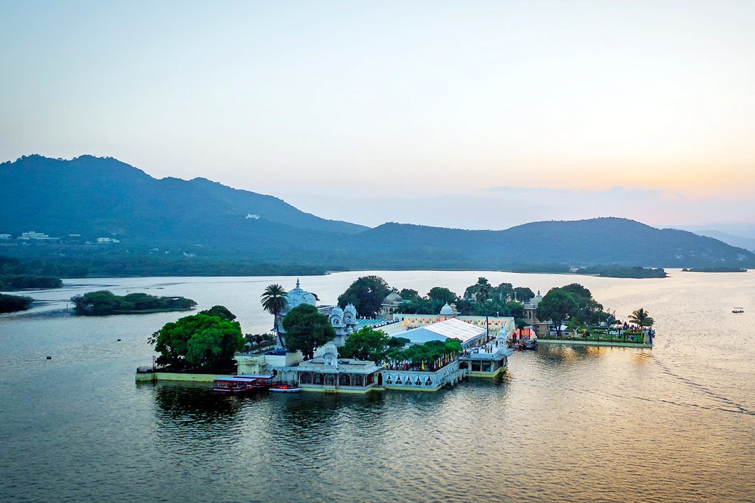 aerial view of jag mandir palace surrounded by a lake in udaipur