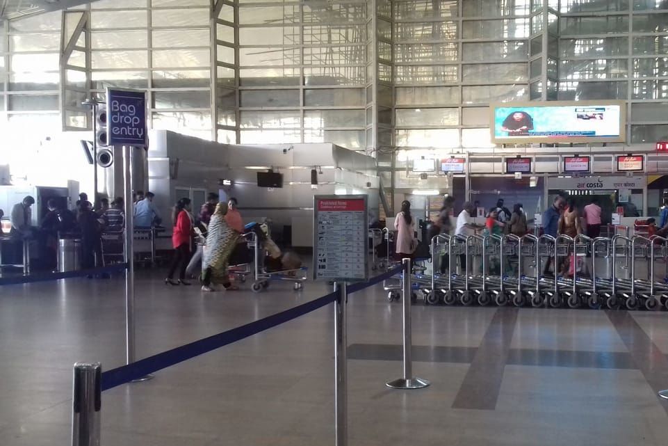 people standing inside jaipur international airport terminal