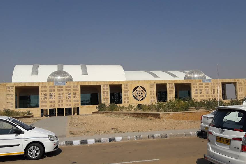 cars standing in front of jaisalmer airport during daytime