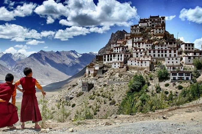 key monastery surrounded by mountains during daytime