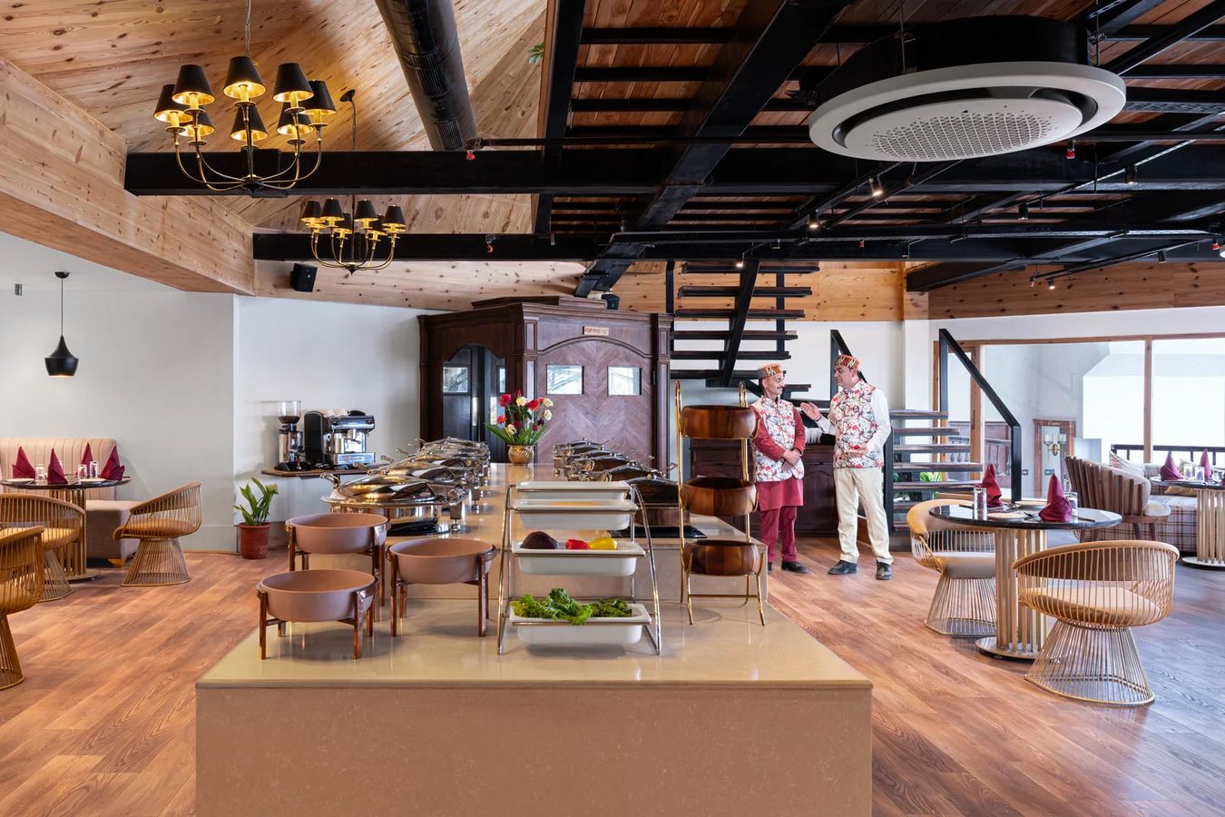 two person standing inside the dining area of kufri heritage resort