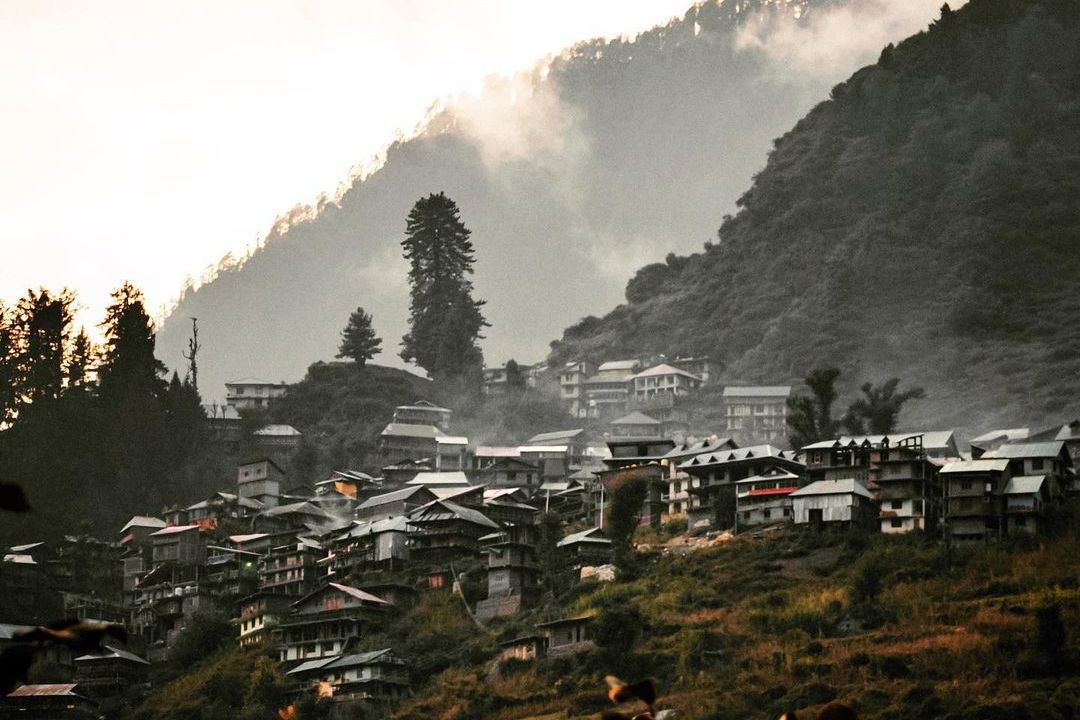 houses in malana village during sunset