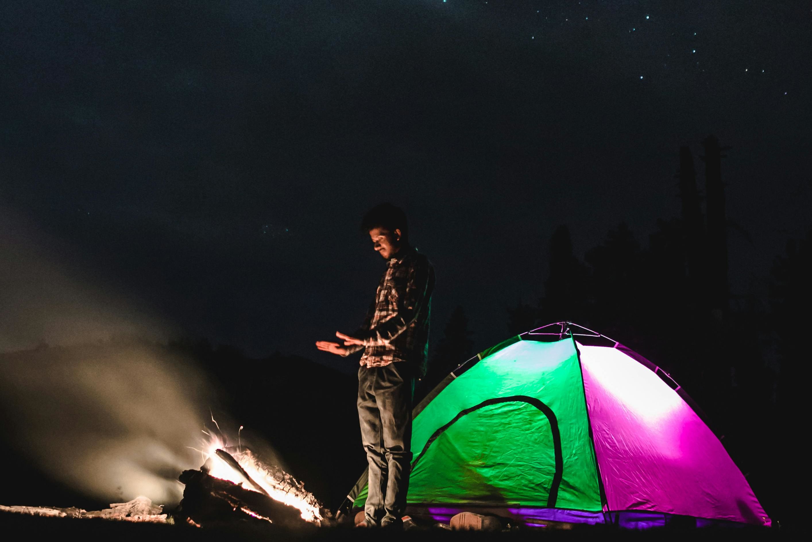 man camping at night