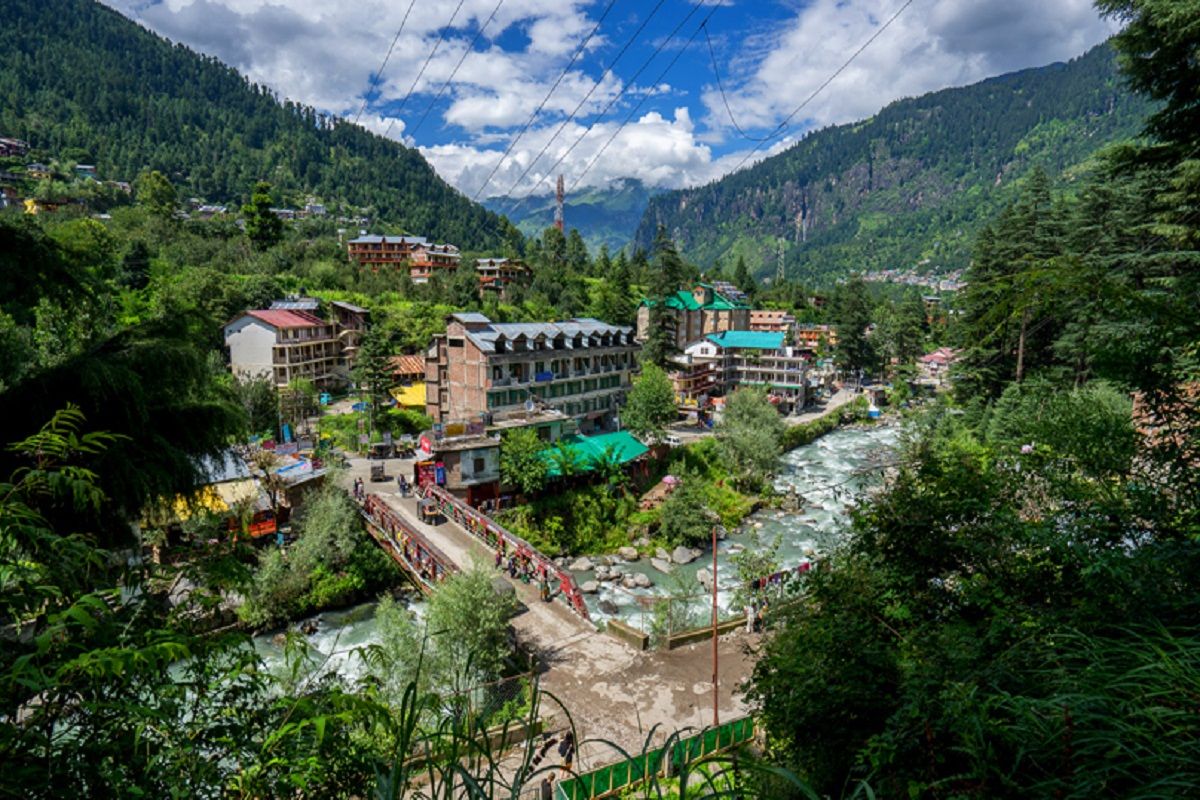 houses beside a river in manali
