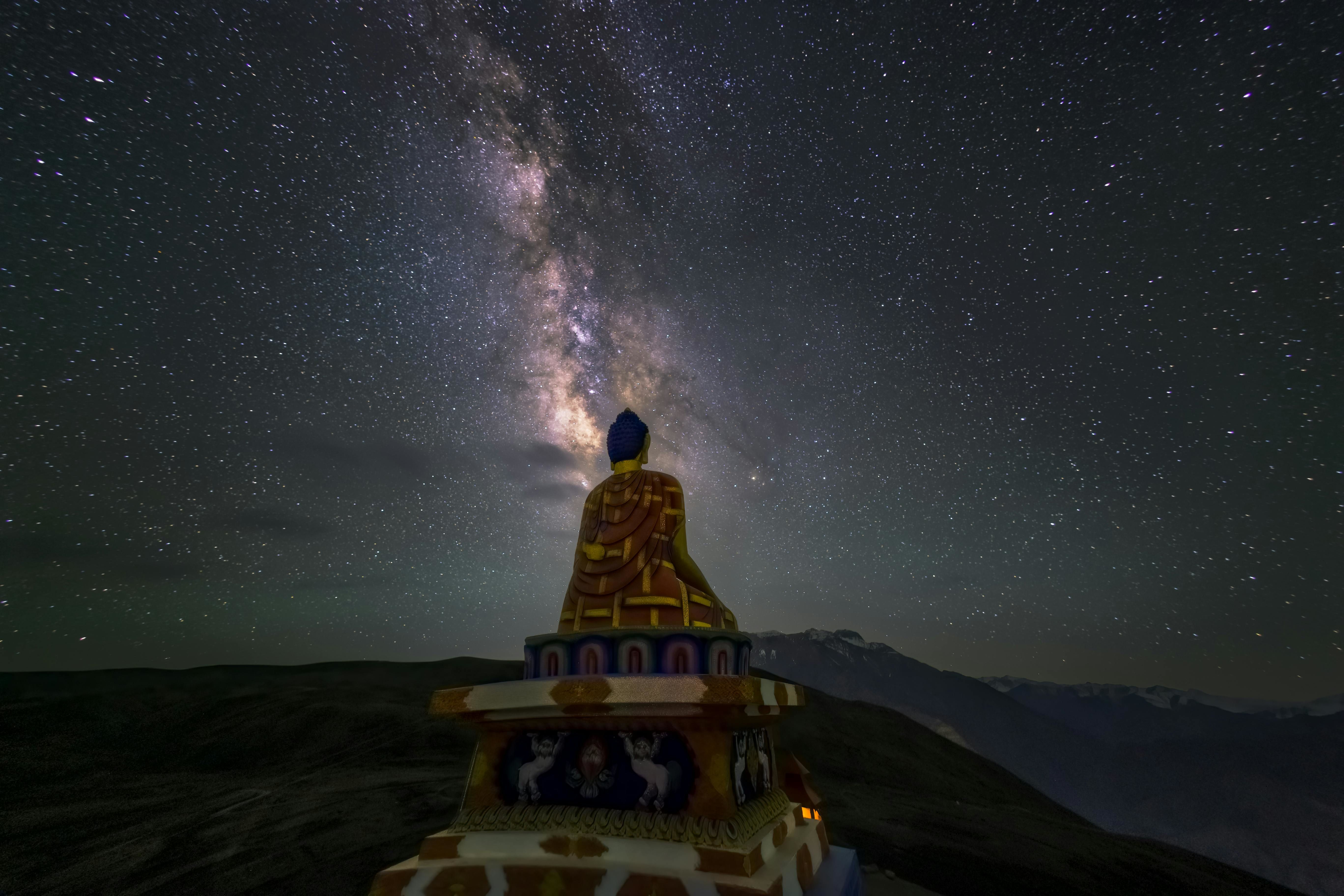 view of the buddha statue in langza village during nighttime