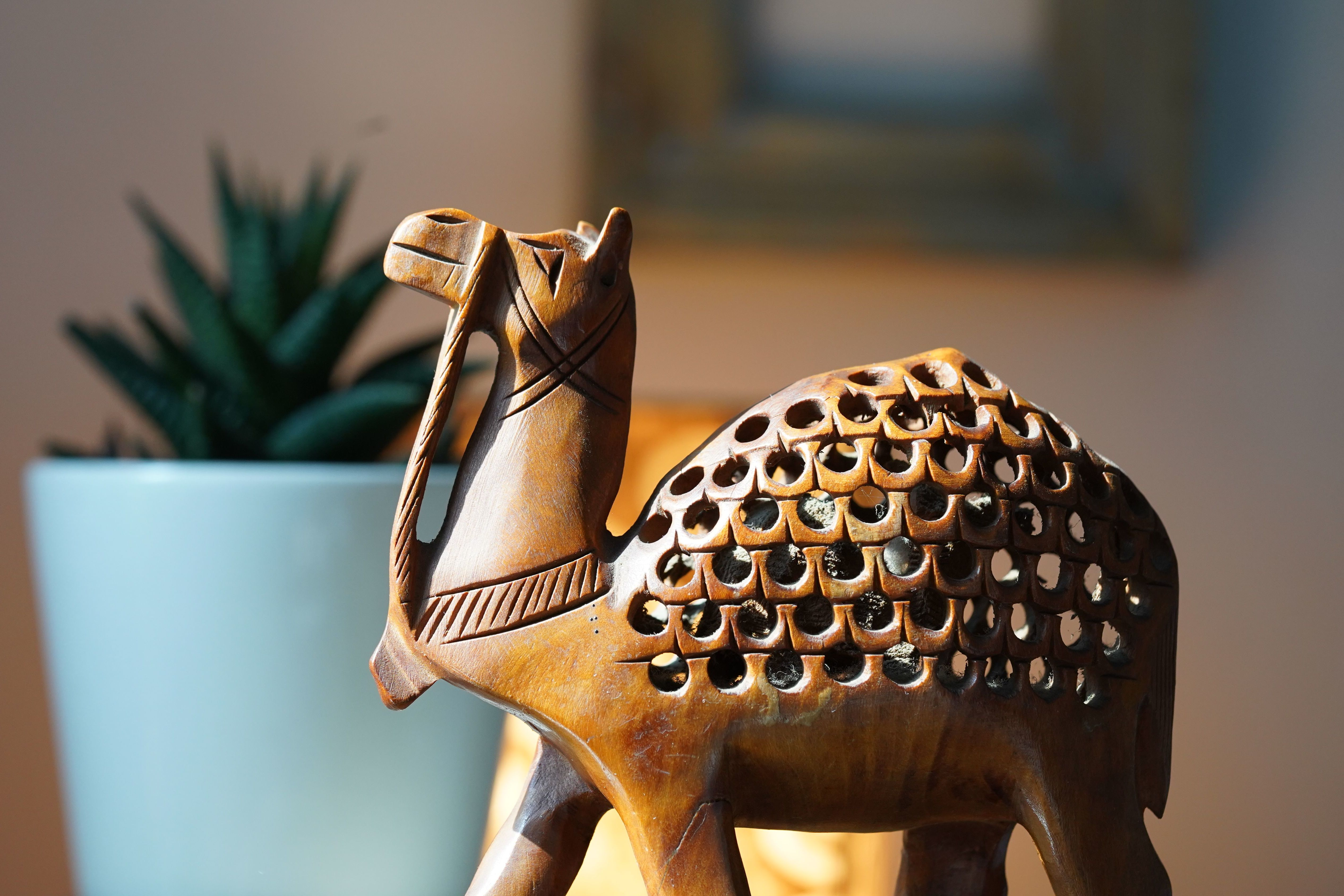 miniature wooden camel sculpture on display in barmer