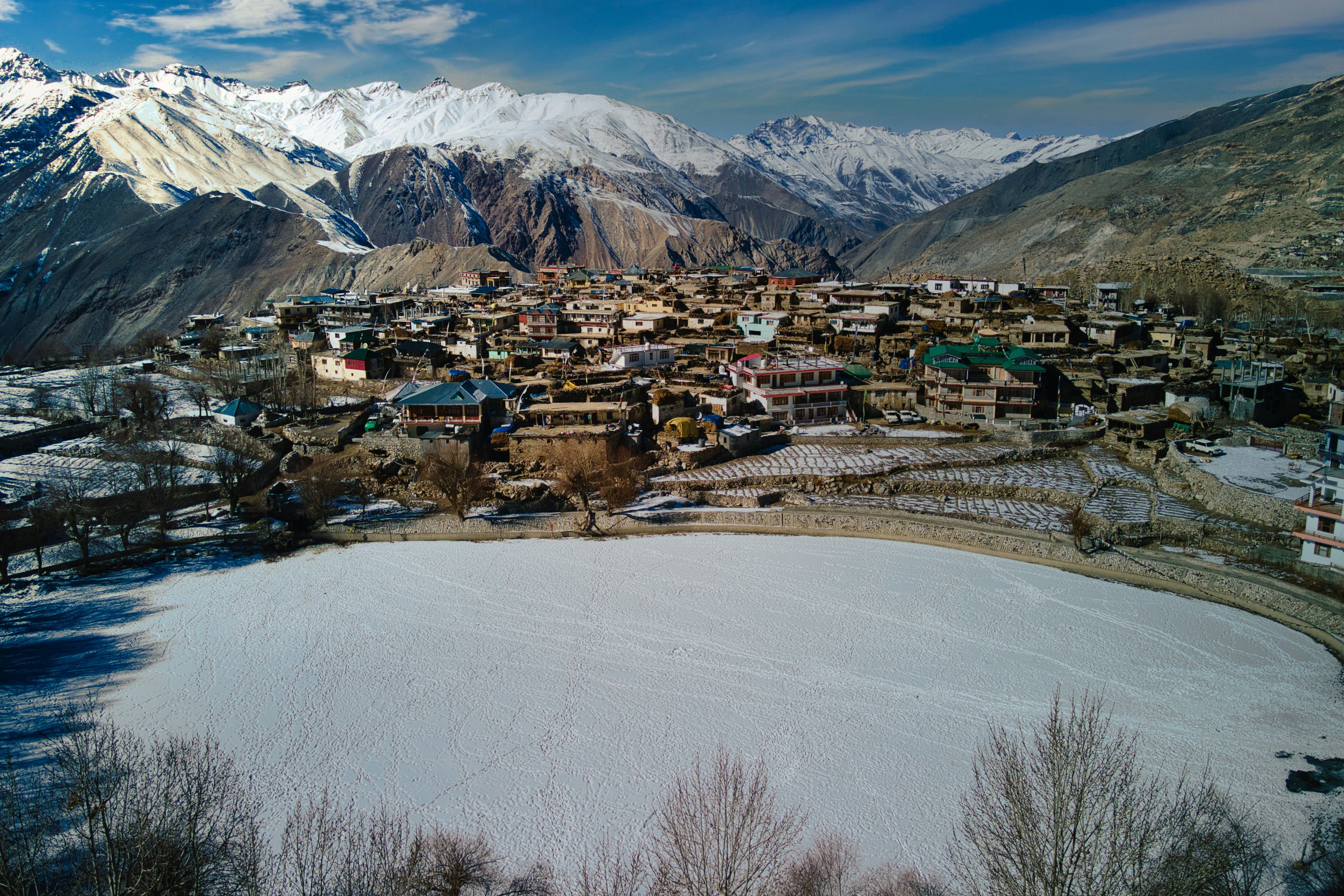 nako town surrounded by snow covered mountains during winters