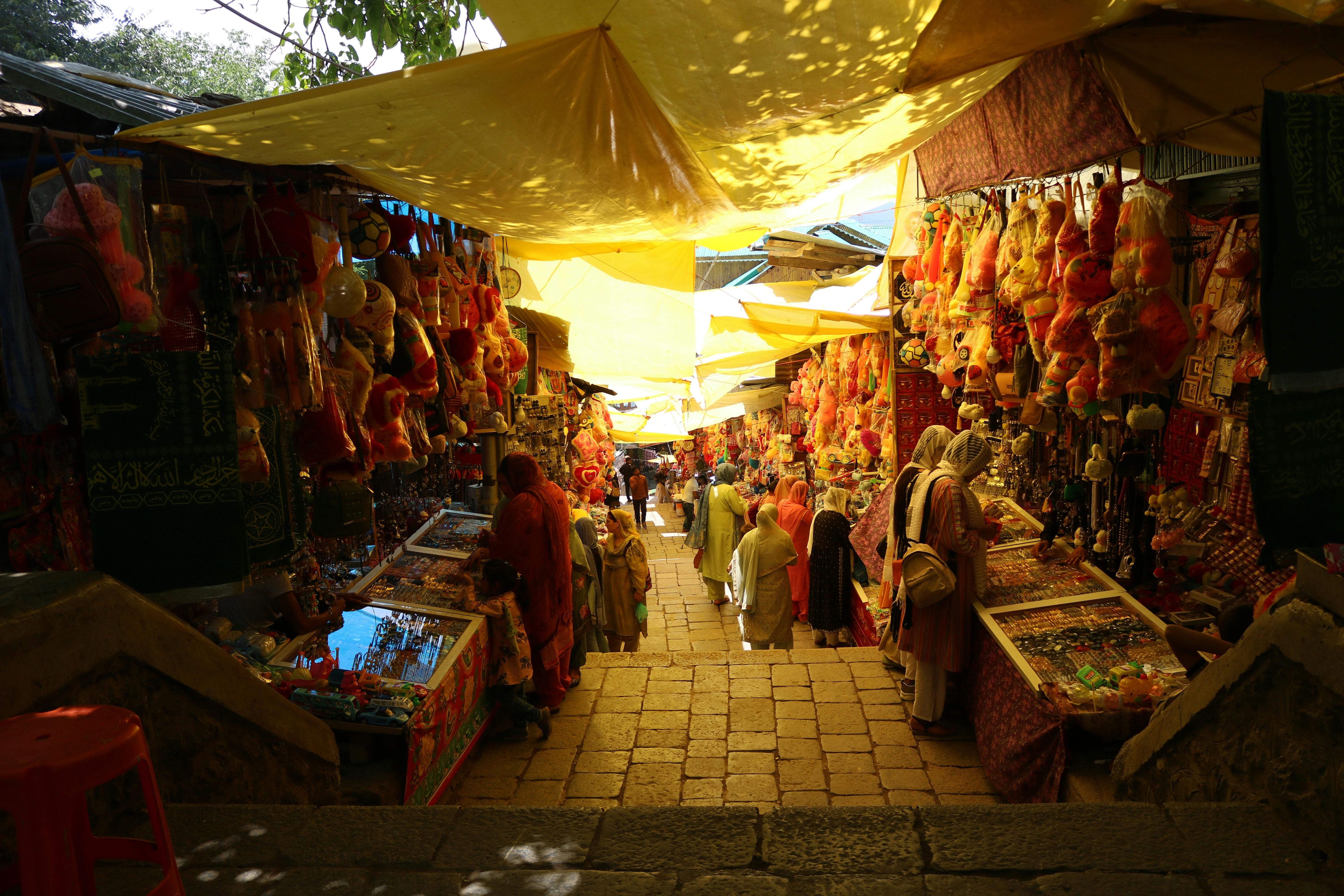 people shopping in a busy market during daytime