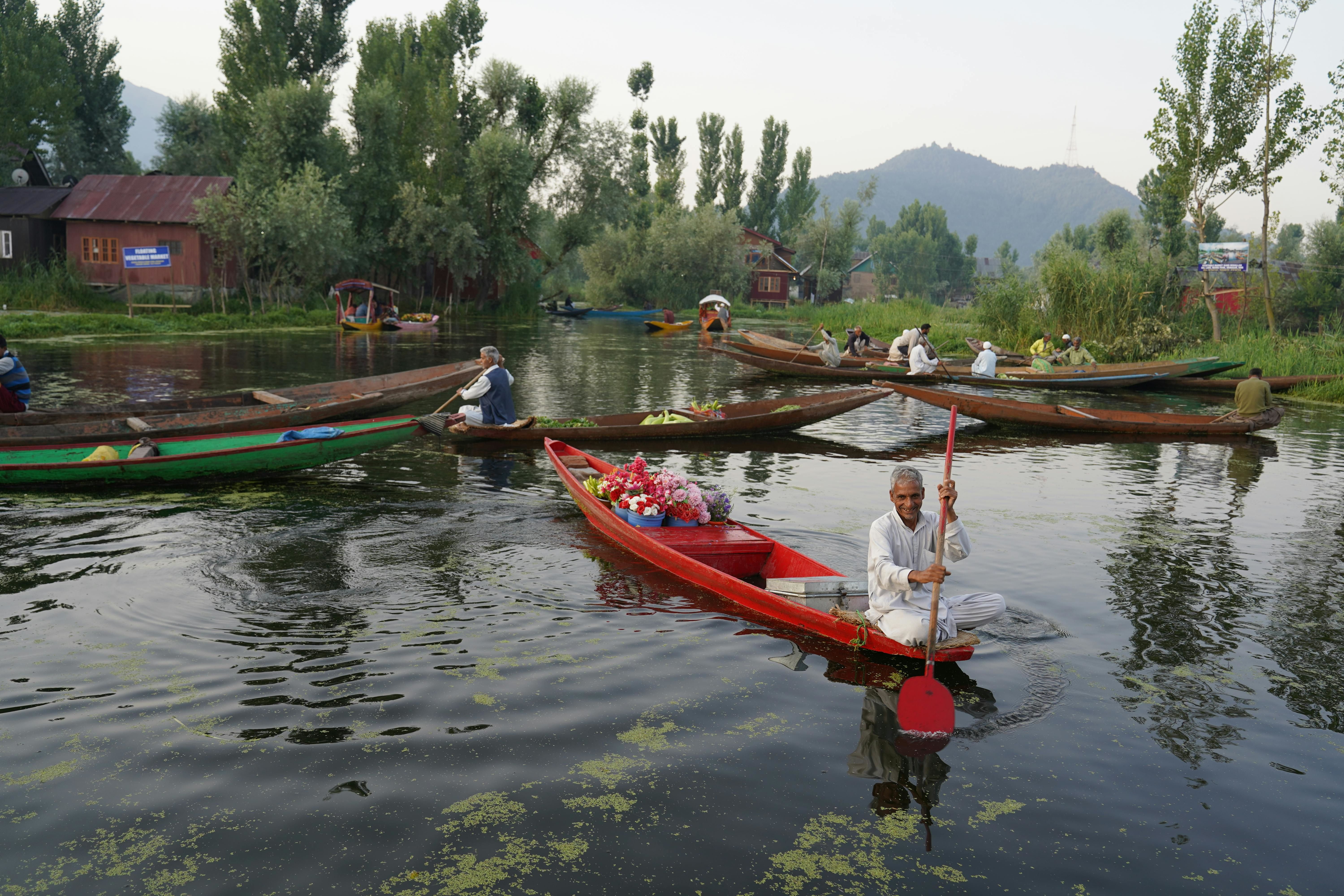 people on boats in dal lake