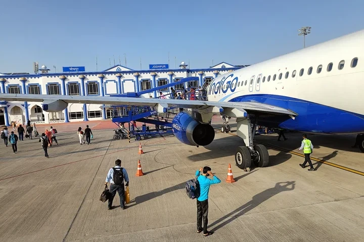 people standing in front of an aeroplane at jodhpur airport