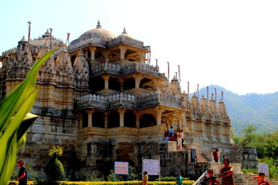 people walking on the stairs of ranakpur jain temple