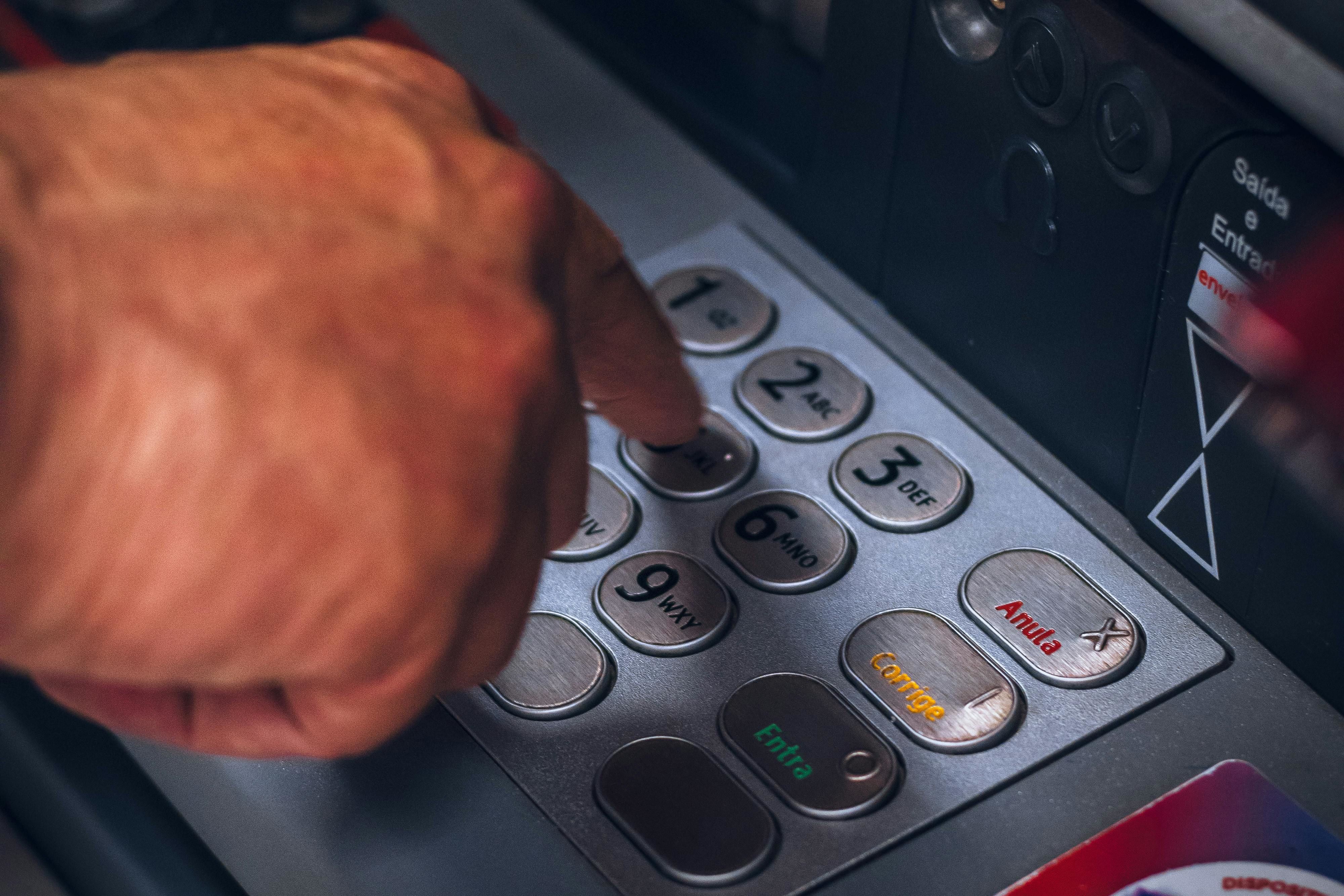 a person pressing keys of an atm
